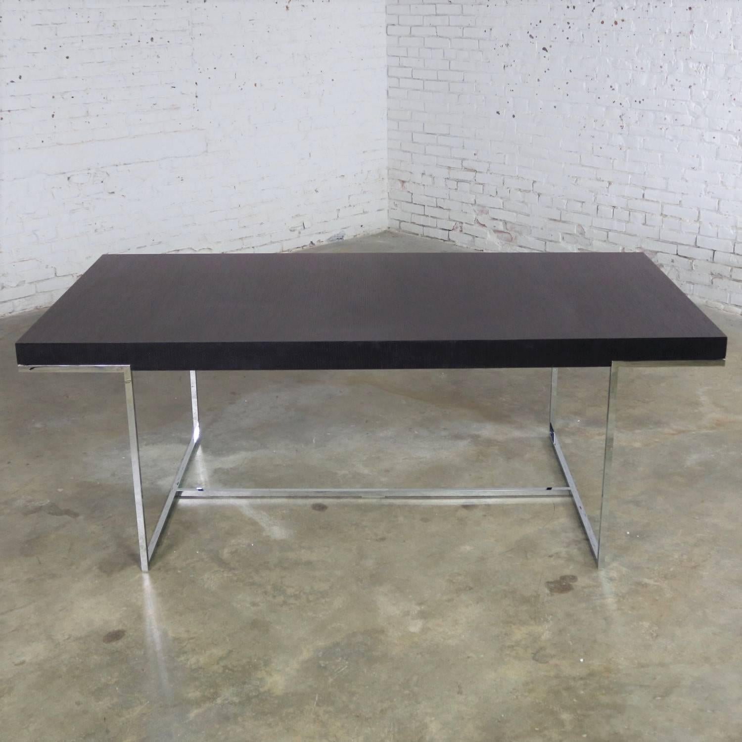 Handsome Athos dining table designed in 2001 by Paolo Piva for B and B Italia with chrome base and dark brown oak veneer top. It is in like-new condition with a fixed size of 78-3/4 inches long by 39-3/8 inches wide, circa 21st century.

We are so