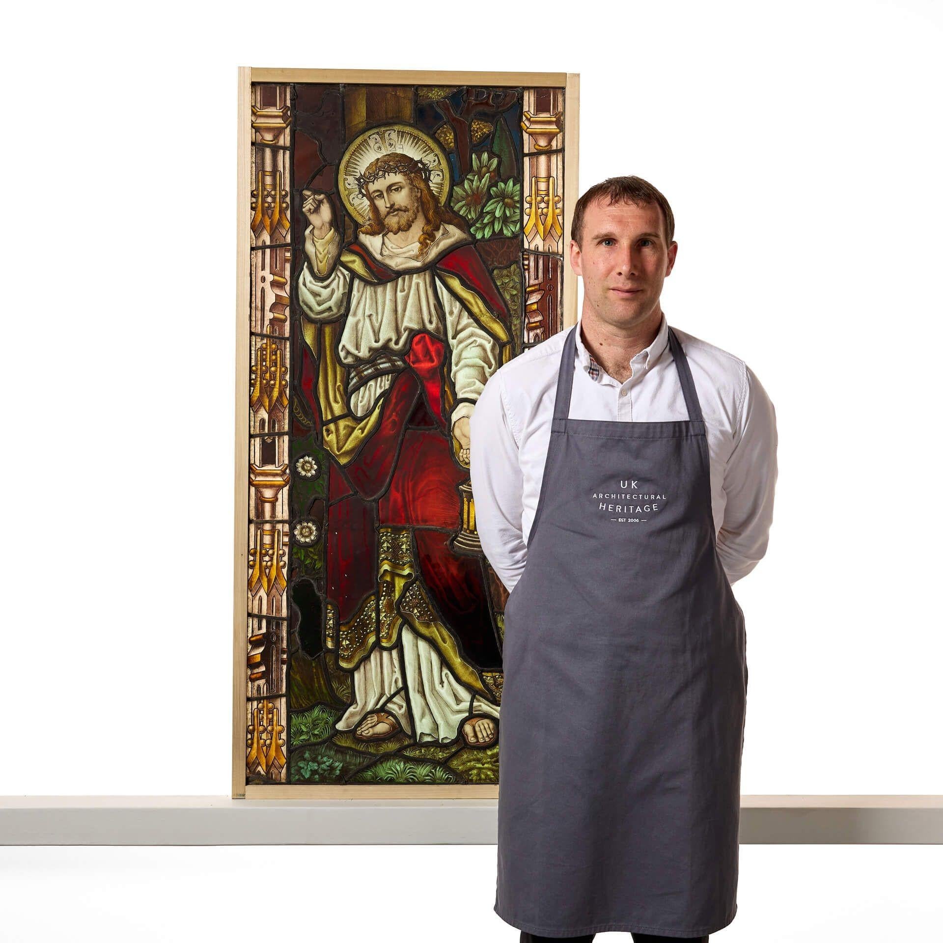 A large and highly detailed religious stained glass window depicting Jesus designed by early 20th century stained glass manufacturers, Atkinson Brothers of Newcastle-Upon-Tyne and manufactured by Hartley Wood & Co Glass Works.

This superb antique