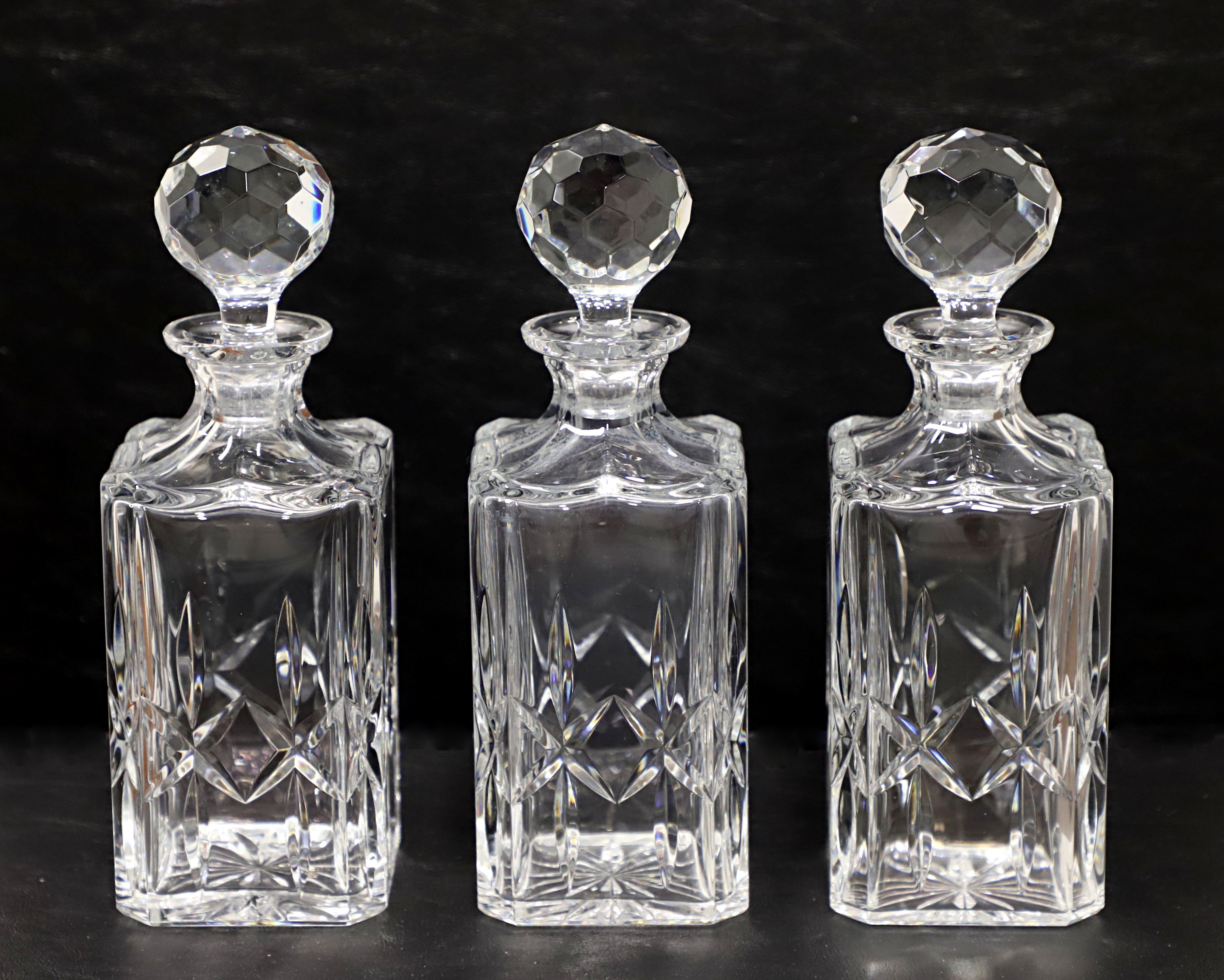 A trio of Late 20th Century crystal decanters by Atlantis Cristasia. Clear lead crystal decanters, square in shape, with same cut diamond pattern to each. Bubbled round shaped all crystal stopper. Made in Alcobaca, Portugal.

Measures:  3.5w 3.5d