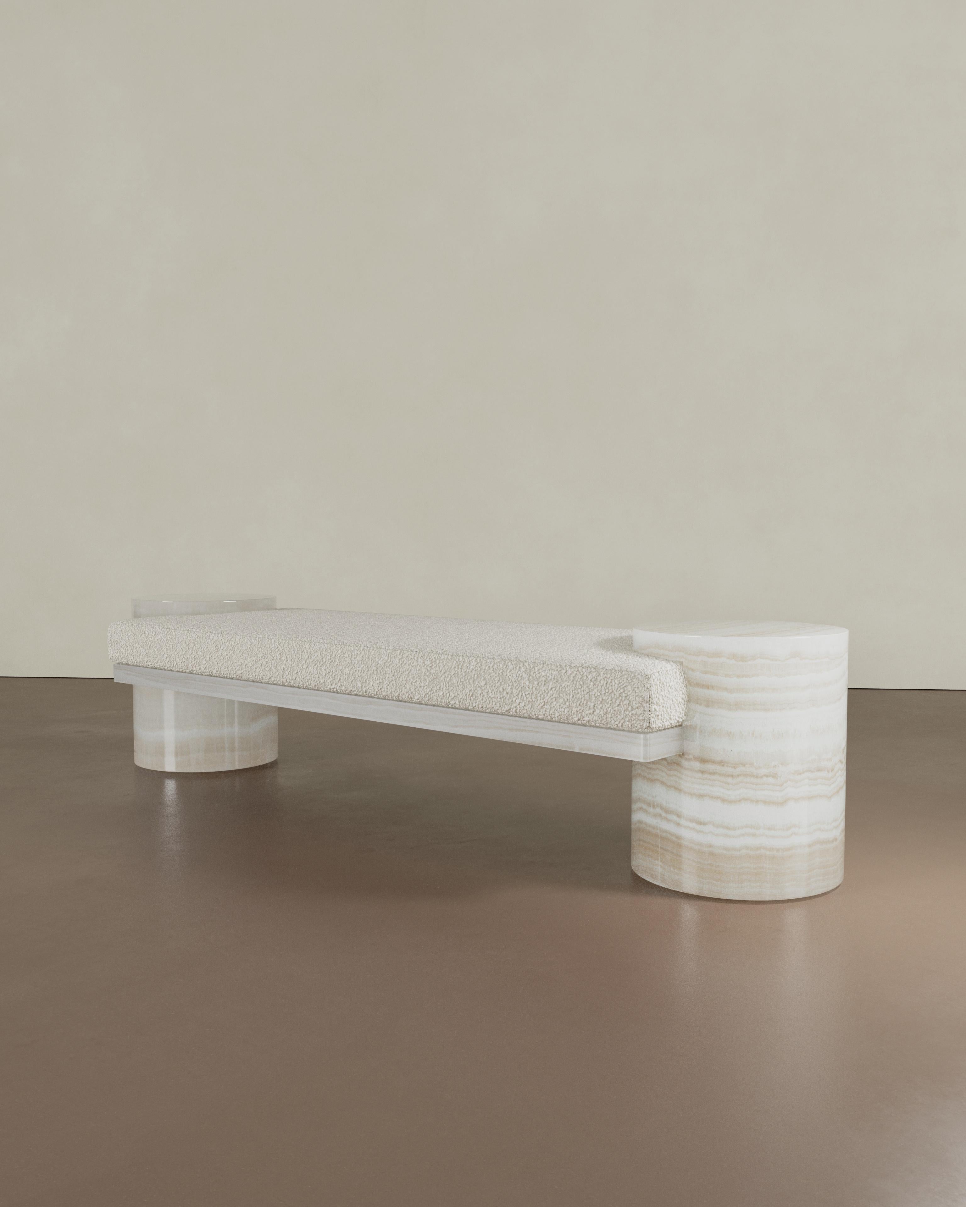 Introducing the Atlas Bench by The Essentialist. The Atlas Bench is a testament to simplicity and innovative design. Drawing from purity of form, it harmoniously merges the solidity of stone with the comfort of upholstery. These distinct materials