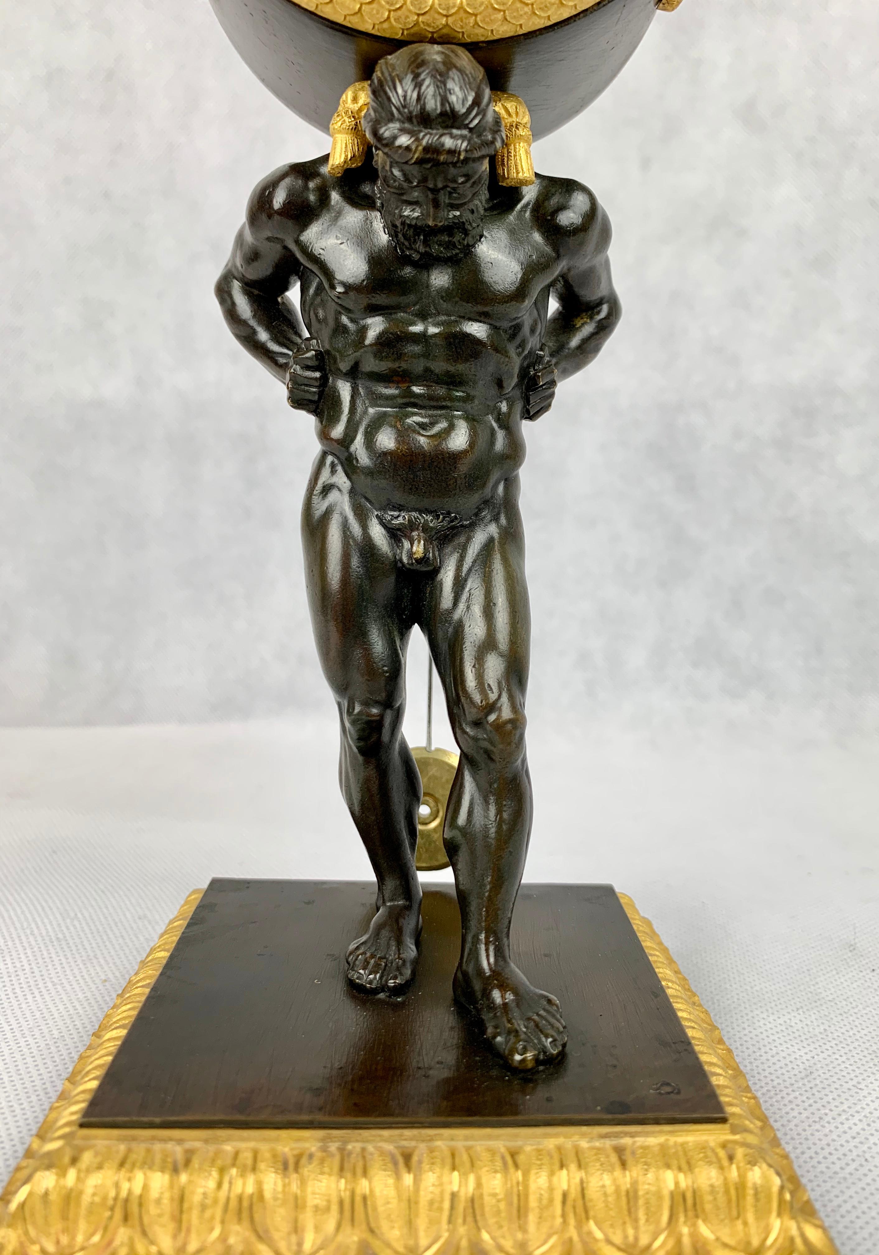 Period French Empire Bronze Doré and Patinated Clock Depicting Atlas with original gilt edged and velvet lined case. Atlas son of Titan, from Greek mythology is holding the clock on his shoulders as if it were the world. Great attention has been