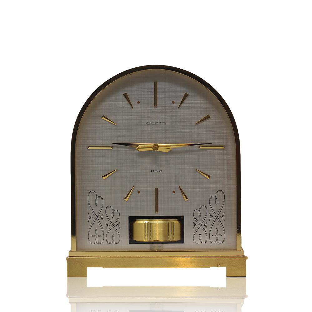 Jaeger-LeCoultre Borne Atmos clock. From our Atmos collection we offer the rare Borne model with beautifully curved top. The clock with an encased movement decorated with ribbon scrollwork to the sides finished in black. The dial shaped to the clock