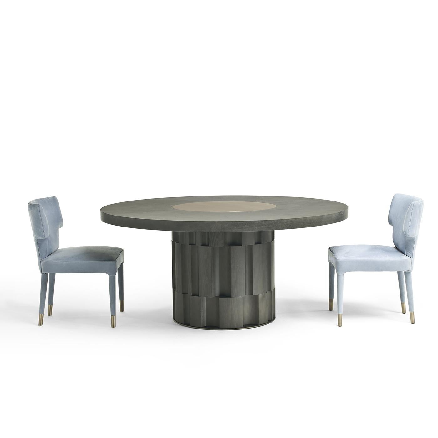 Make a strong style statement in a contemporary dining space with the Atmos Dining Table. On a solid open-pore oak base with a black finish, the table has a round top featuring a chic lazy Susan in bronze-plated brass. Pair the table with minimalist