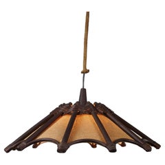 Atmospheric rattan Manou pendant lamp with wood and jute.