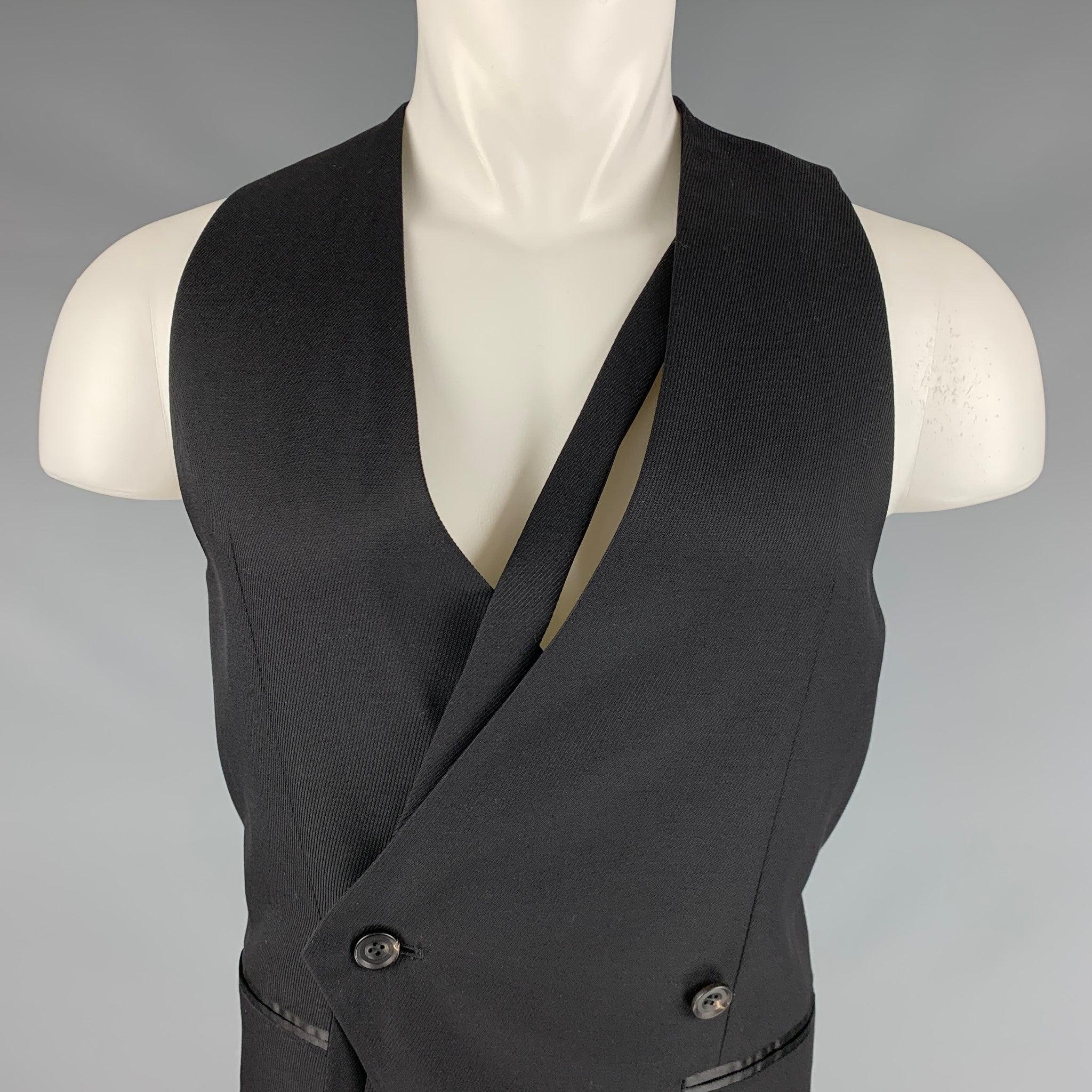 ATO vest
in a black wool silk blend fabric featuring a double breasted style, versatile belt, and two small pockets. Made in Japan.Excellent Pre-Owned Condition. 

Marked:   46 

Measurements: 
 
Shoulder: 11 inches Chest: 36 inches Length: 21