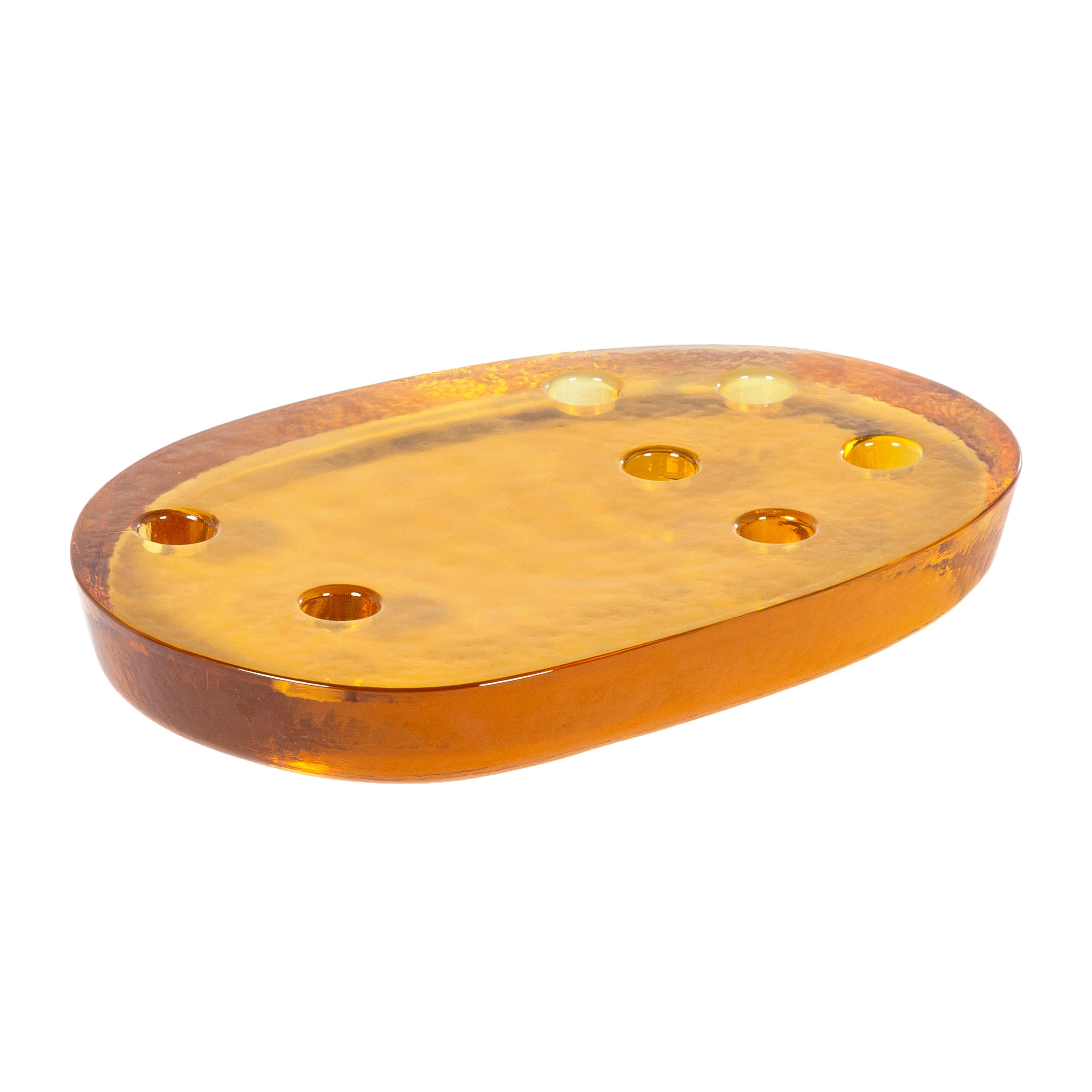 Atoll Big Amber candle holder by Pulpo
Dimensions: D32 x W22 x H4 cm
Materials: casted glass

Also available in different colours. 

These simple forms refer to the free-form nature of volcanic islands – much like the changing of glass from