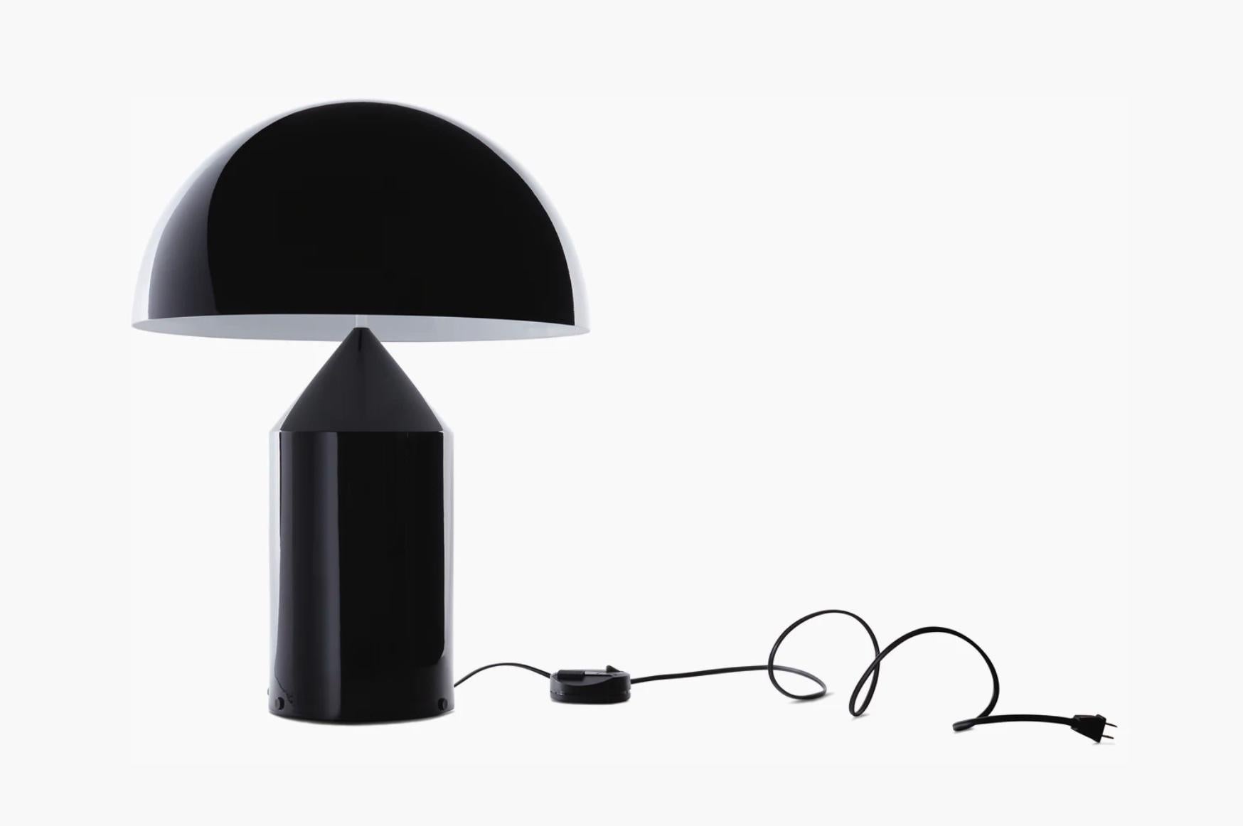 Iconic Atollo model 238 table lamp originally designed by Vico Magistretti for Oluce in 1977. Provides direct light as a table or bedside lamp. All gloss black painted aluminum. Also comes in opal glass, or gold brass. Power switch on cord. Takes