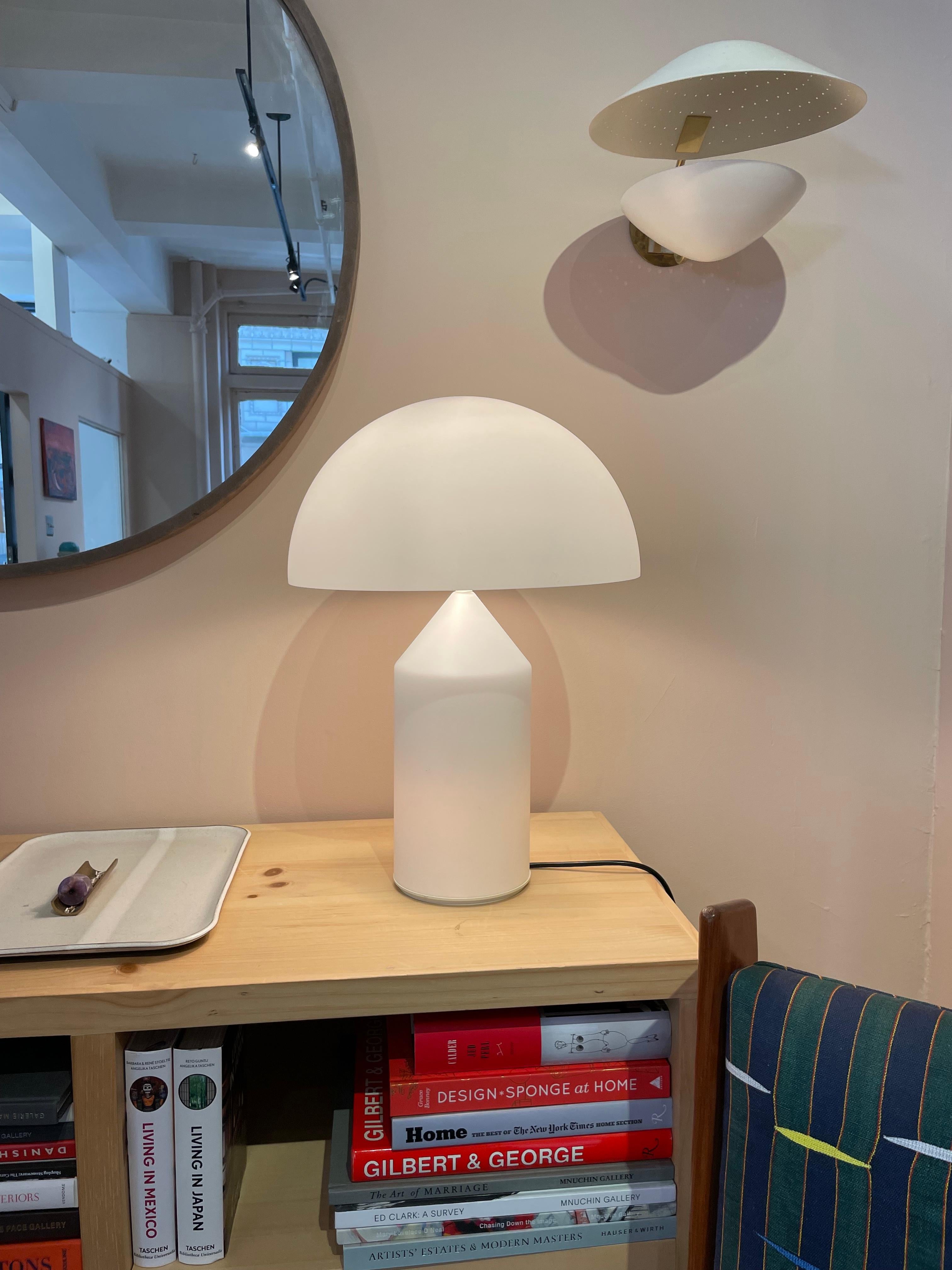 The iconic 'Atollo' Table Lamp designed by Vico Magistretti in 1977. Crafted with a white glass shade, this timeless piece adds a touch of elegance to any interior. Newly rewired for use in the US, ready to illuminate your space.