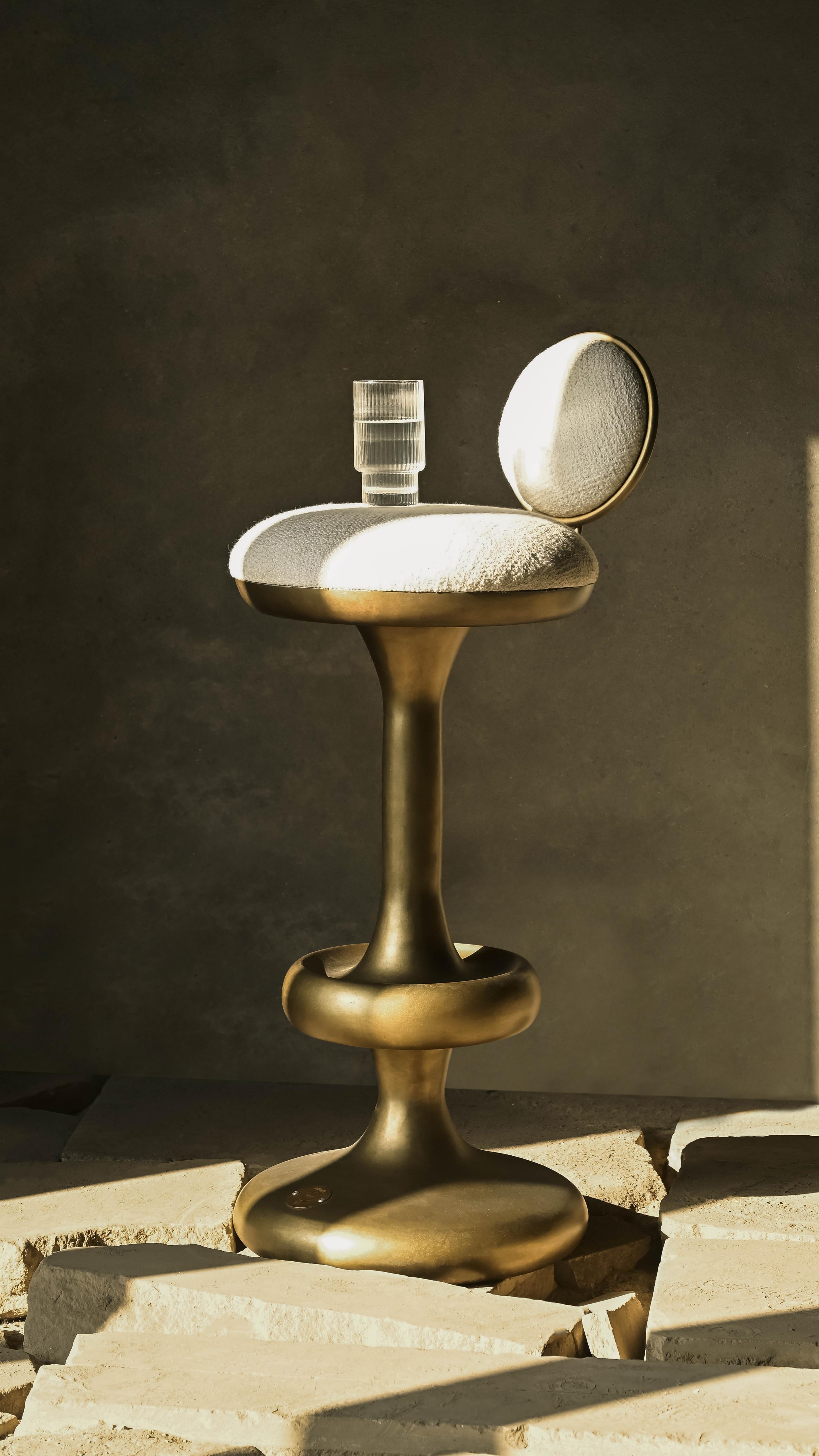Where science meets style—quite literally. The Atom Bar Stool takes its bold, sculptural form from the mushroom cloud, a shape born of immense energy and impact. Crafted from lightweight aluminum with a golden finish that shines brighter than your