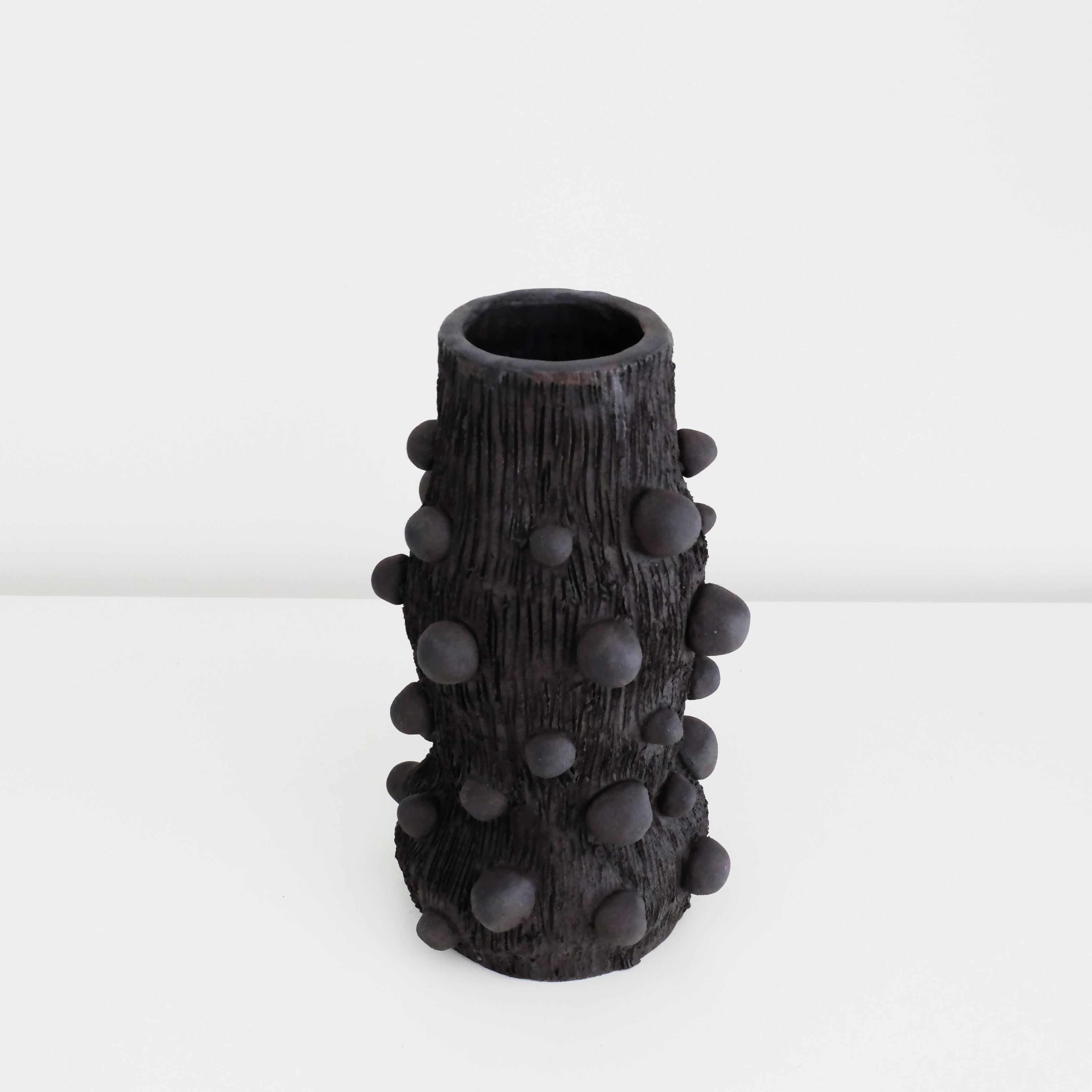 Atom Vase by Ia Kutateladze
One Of A Kind
Dimensions: W 10 x H 21 cm.
Materials: Black clay.

Handbuilt from black clay. Each piece is one of a kind, due to its free hand-building process. Please contact us. 

Atom is a vase with an unique