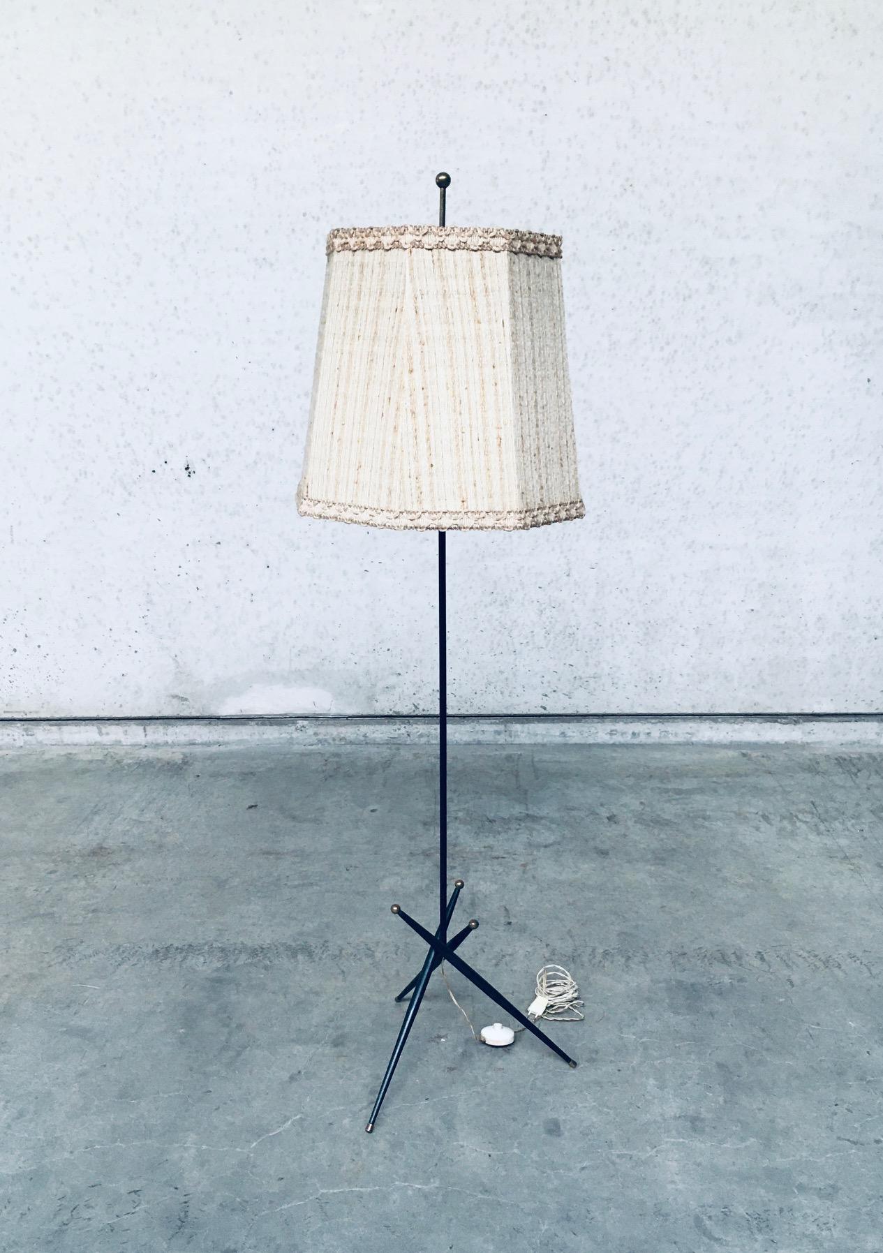Vintage Midcentury Modern Belgian Design Atomic Age Floor Lamp, made in Belgium 1950's. Black laquered metal base with brass tips and original beige boucle fabric lampshade. The metal lamp is in very good, original condition. Lampshade in well used