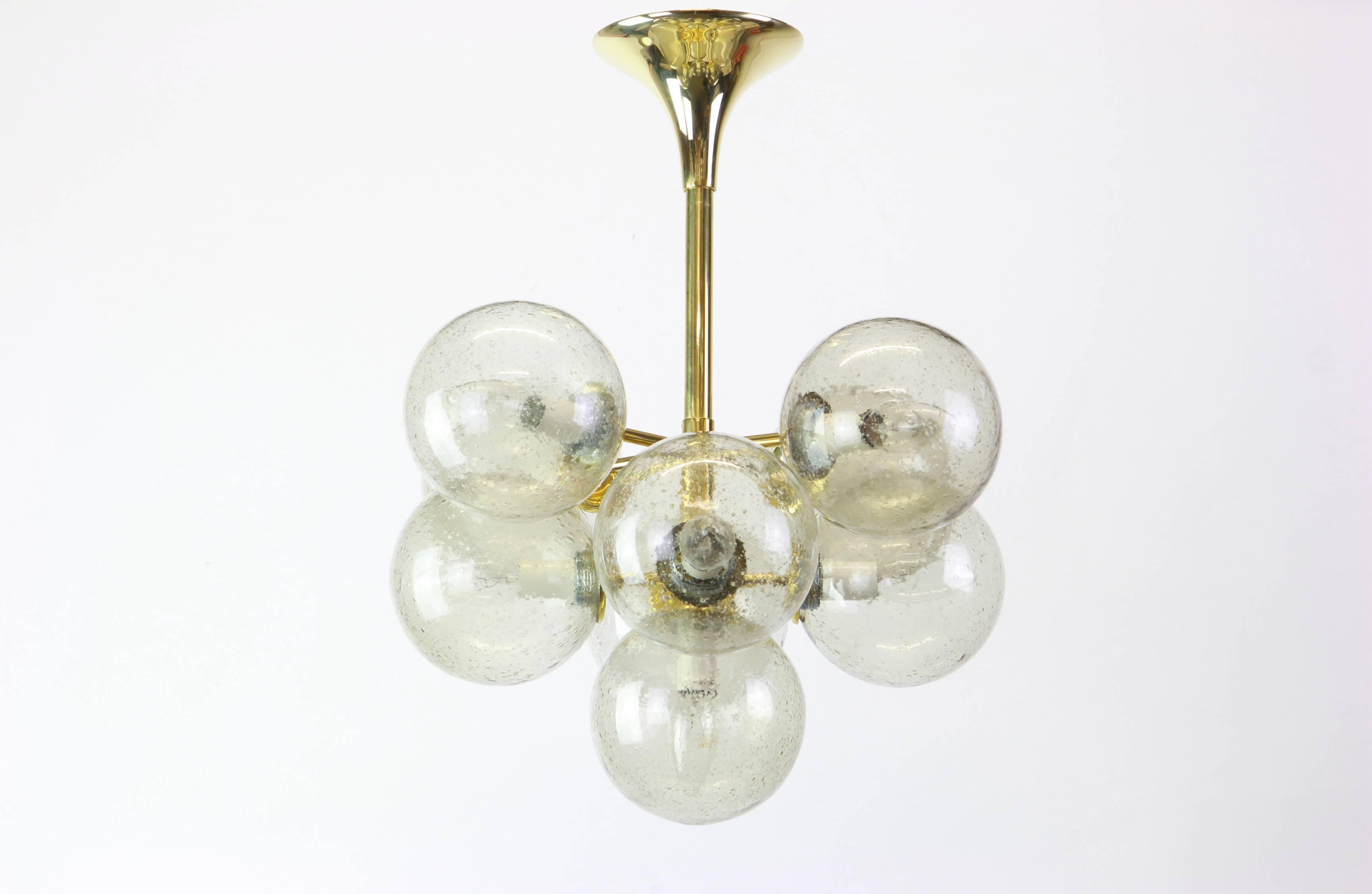Atomic chandelier with nine-glass globes was designed by the Swiss artist and designer Max Bill for Temde Leuchten. The globes are hand blown and fitted with a screwing device.

High quality and in very good condition. Cleaned, well-wired and ready
