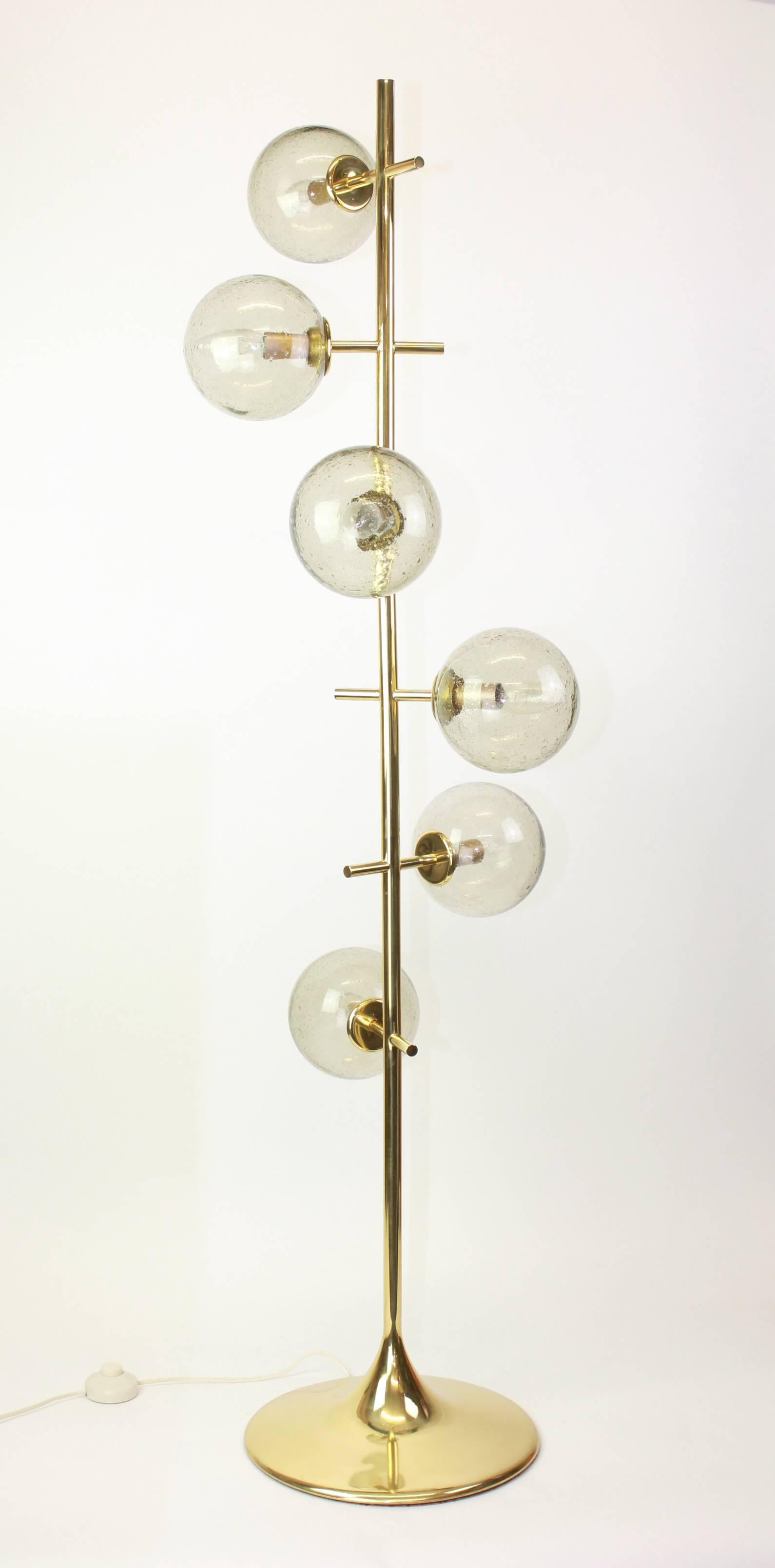 Atomic floor lamp with six-glass globes was designed by the Swiss artist and designer Max Bill for Temde Leuchten. The globes are handblown and fitted with a screwing device.

High quality and in very good condition with a tiny dent on the brass
