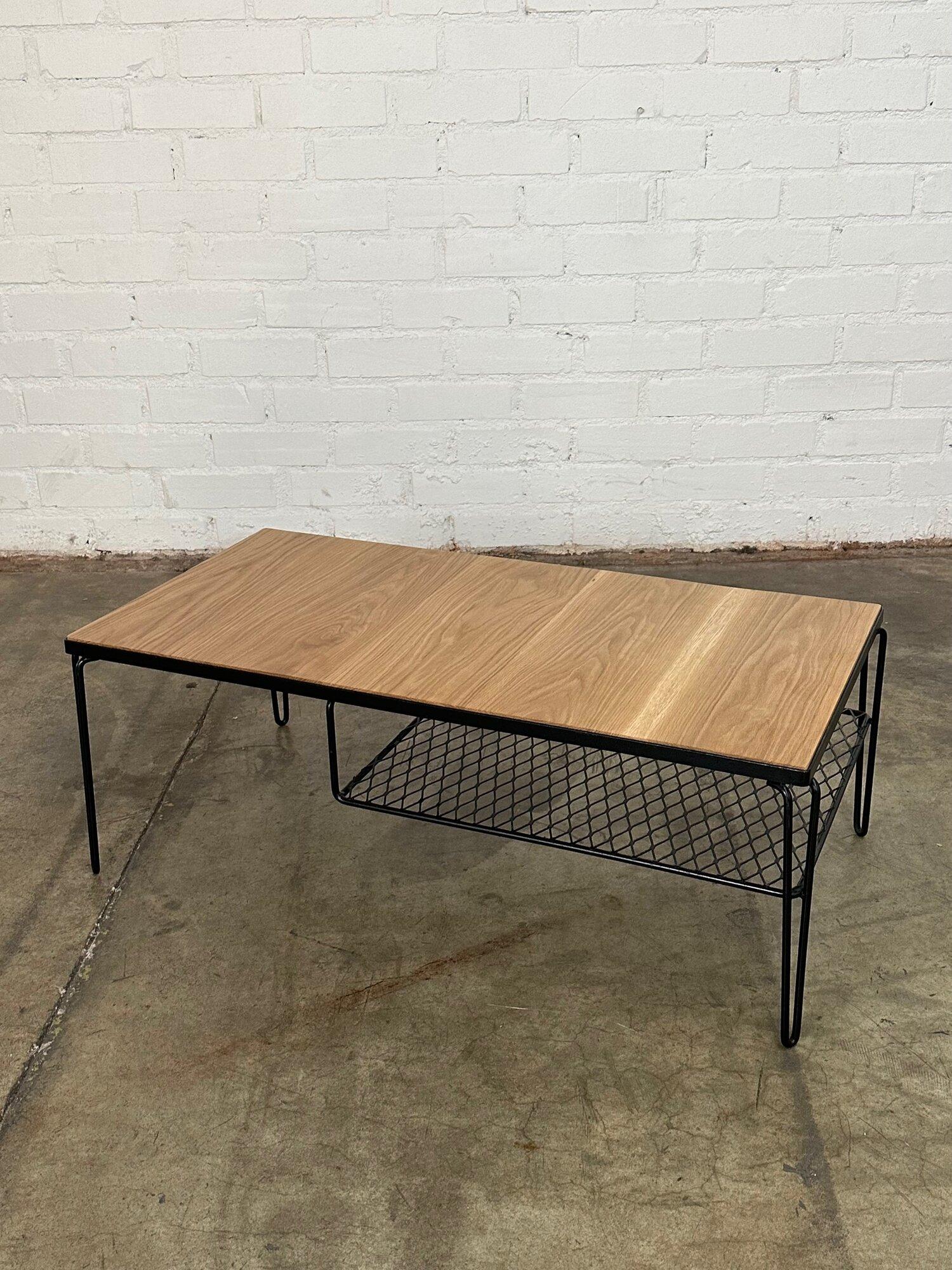 W40 D20 H15

Fully restored oak and iron coffee table. Item is structurally sound and sturdy with no major areas of wear. Surface wood has a clear coat showing natural grain hues. 
