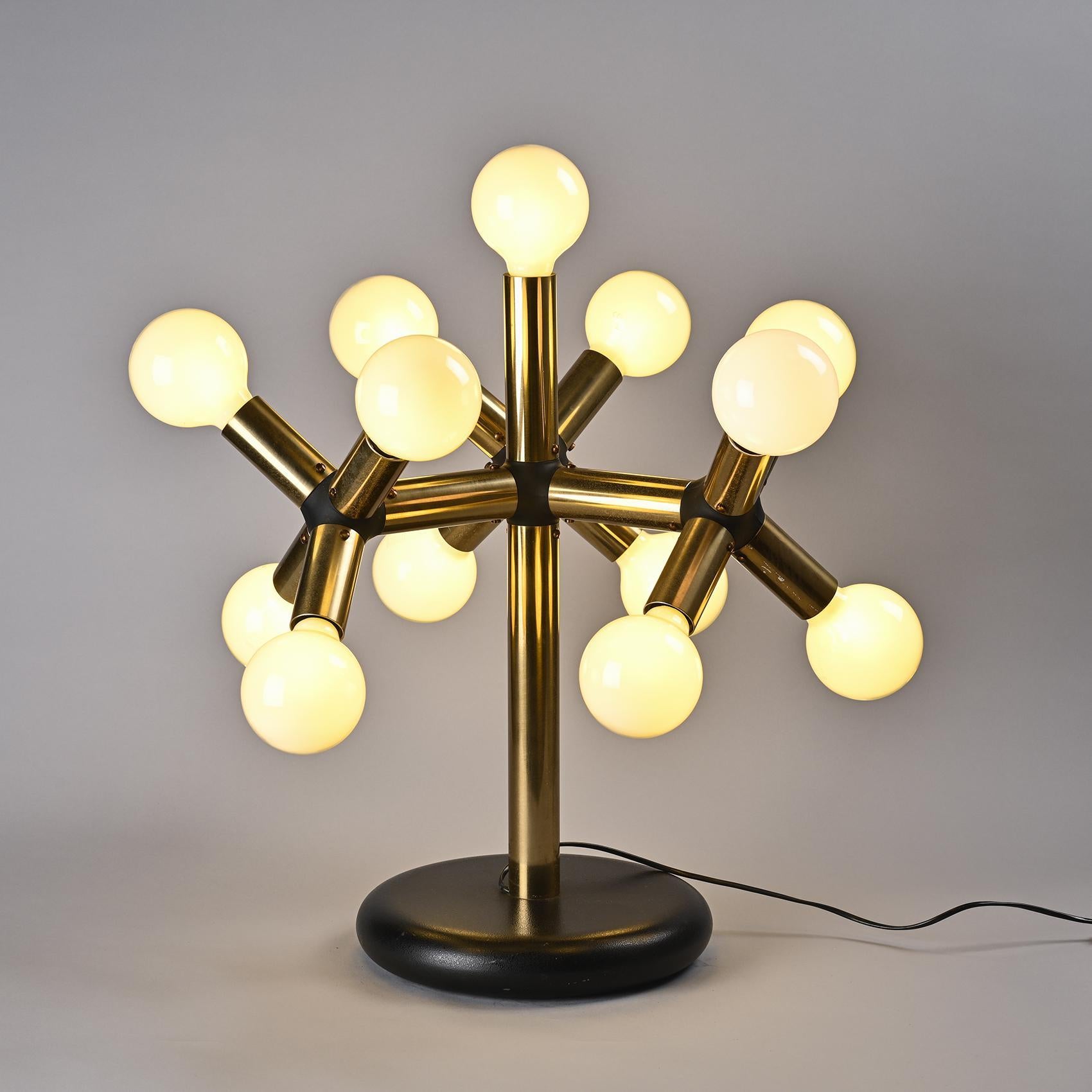 
An original table lamp, reminiscent of the shape of an atom, by the Swiss designer couple Robert and Trix Haussmann.

The heavy circular base welcomes an aluminum shaft and tubes linked by plastic connections accommodating 13 lights.
