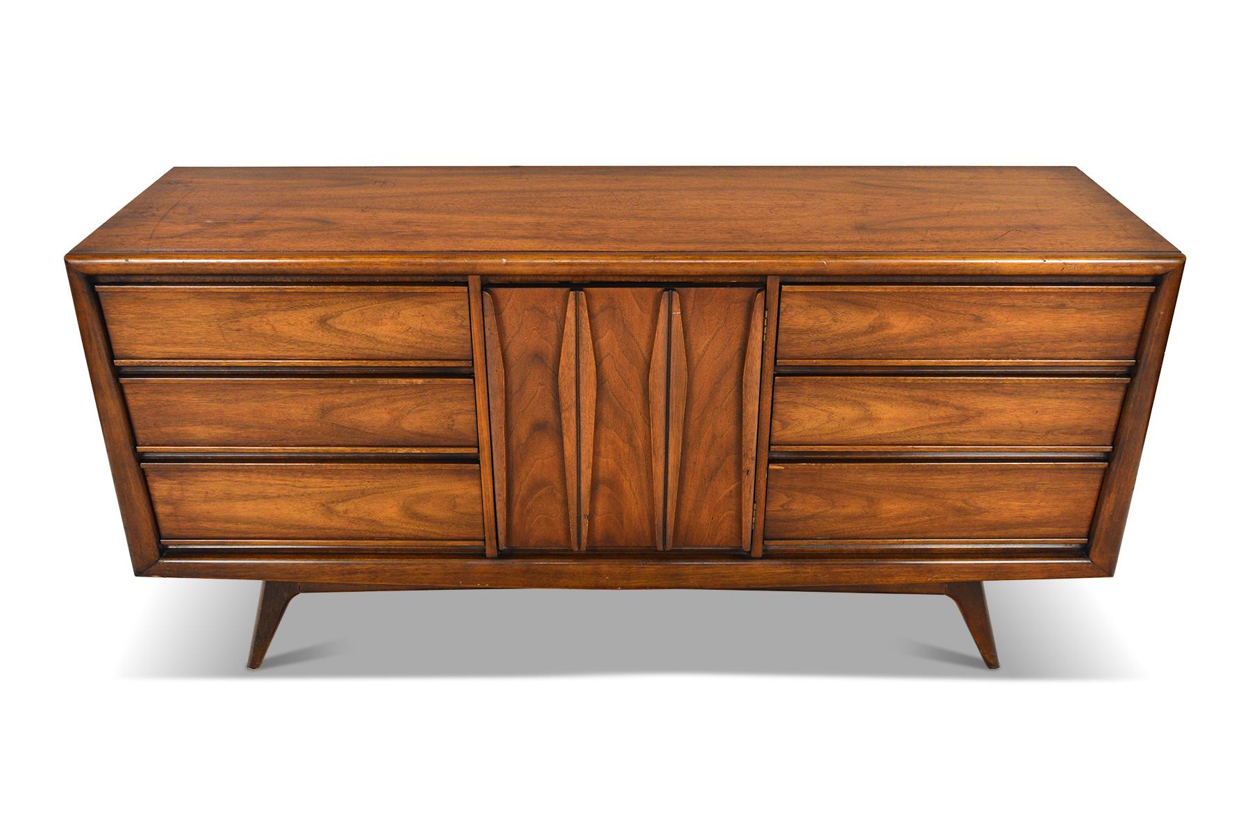 This low midcentury dresser was designed by United in the 1960s. In good original condition with light cosmetic wear.

Measurements: 66 wide x 19 deep x 32 tall
Drawer: 20.5 wide x 15.5 deep x 4.5 tall.