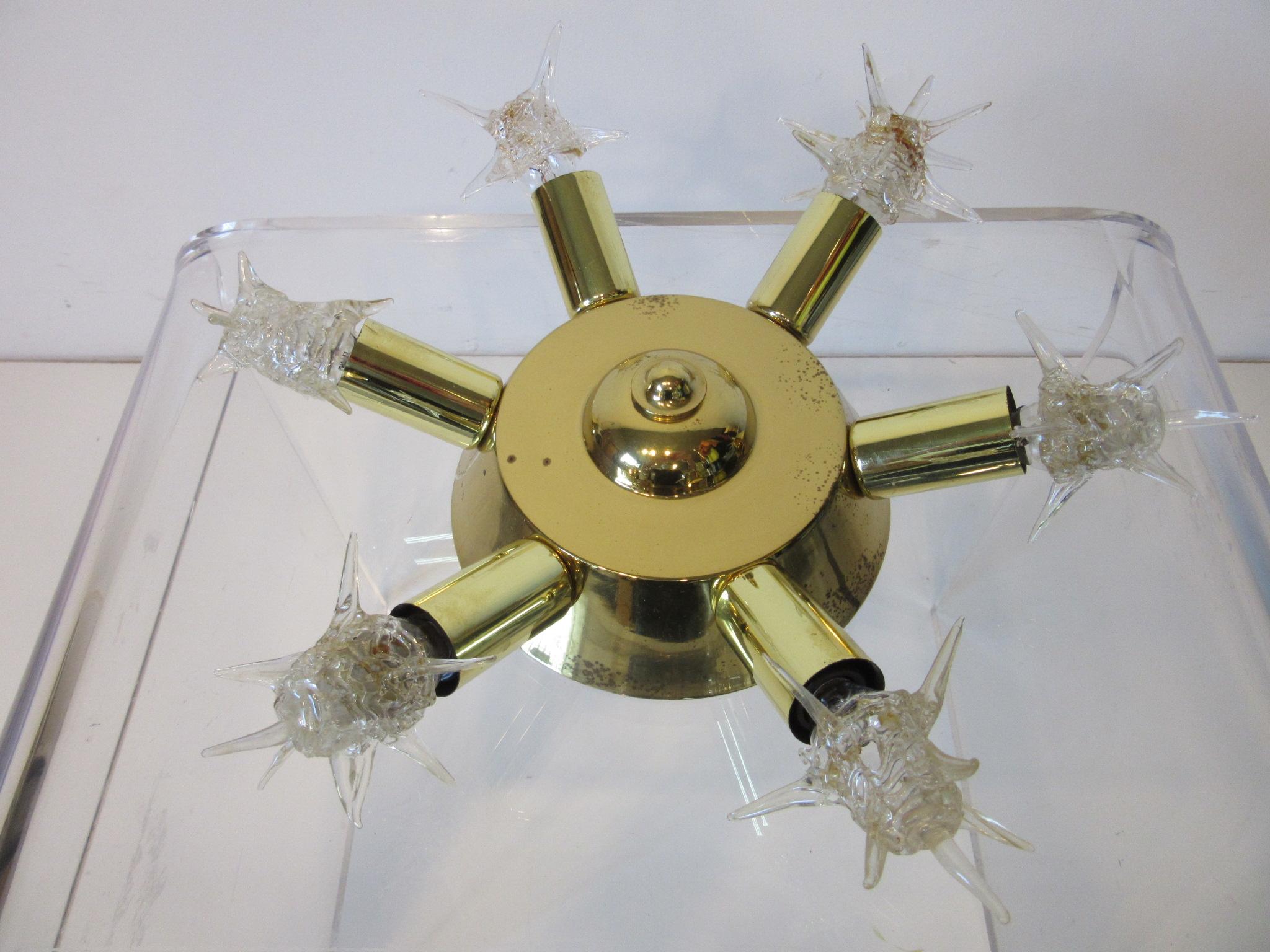 A brass Atomic Starburst ceiling fixture with six radiating arms having the starlight bulbs which can still be ordered. This was meant to be used on the ceiling and wires right into the ceiling box, unlike the hanging Atomic chandelier these were