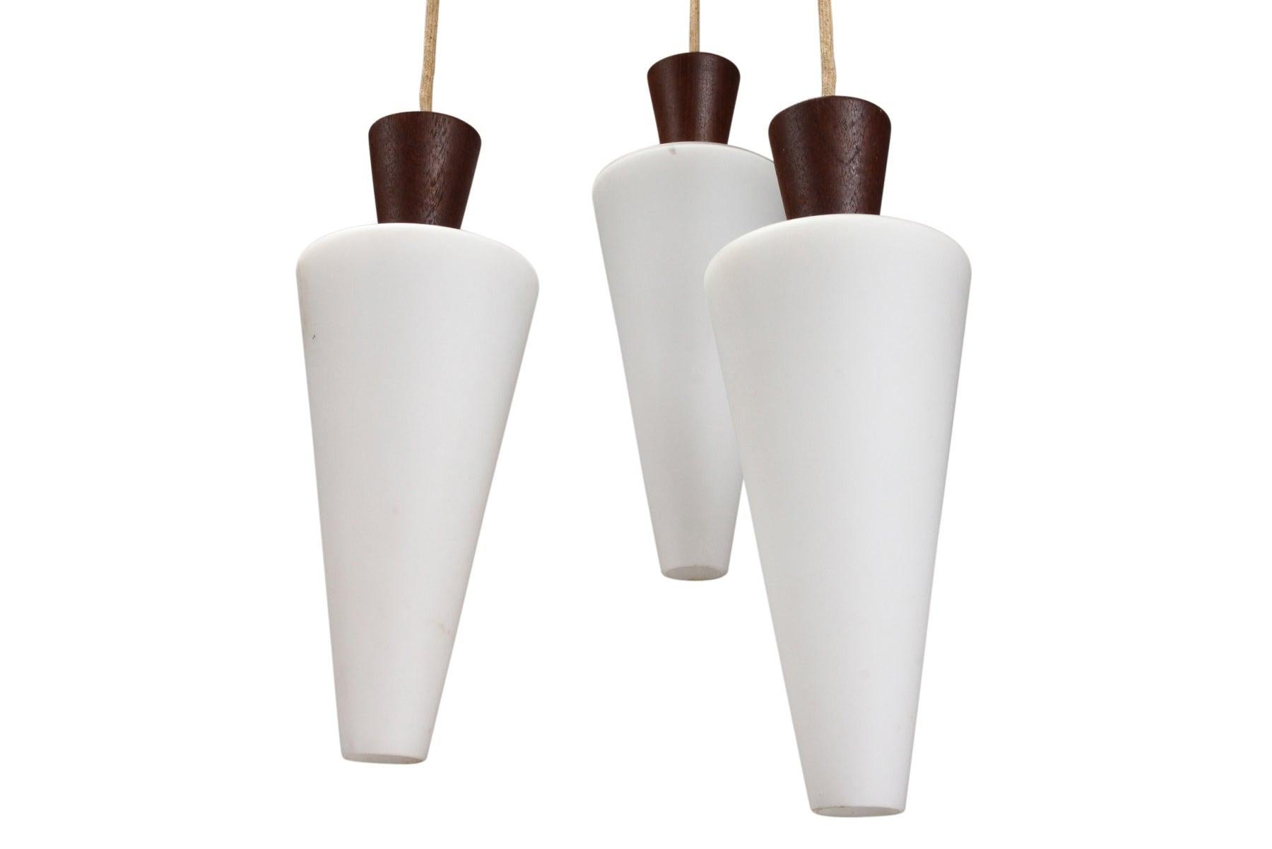 20th Century Atomic Tri-Pendant Lamp In Teak With Frosted Glass Cones For Sale