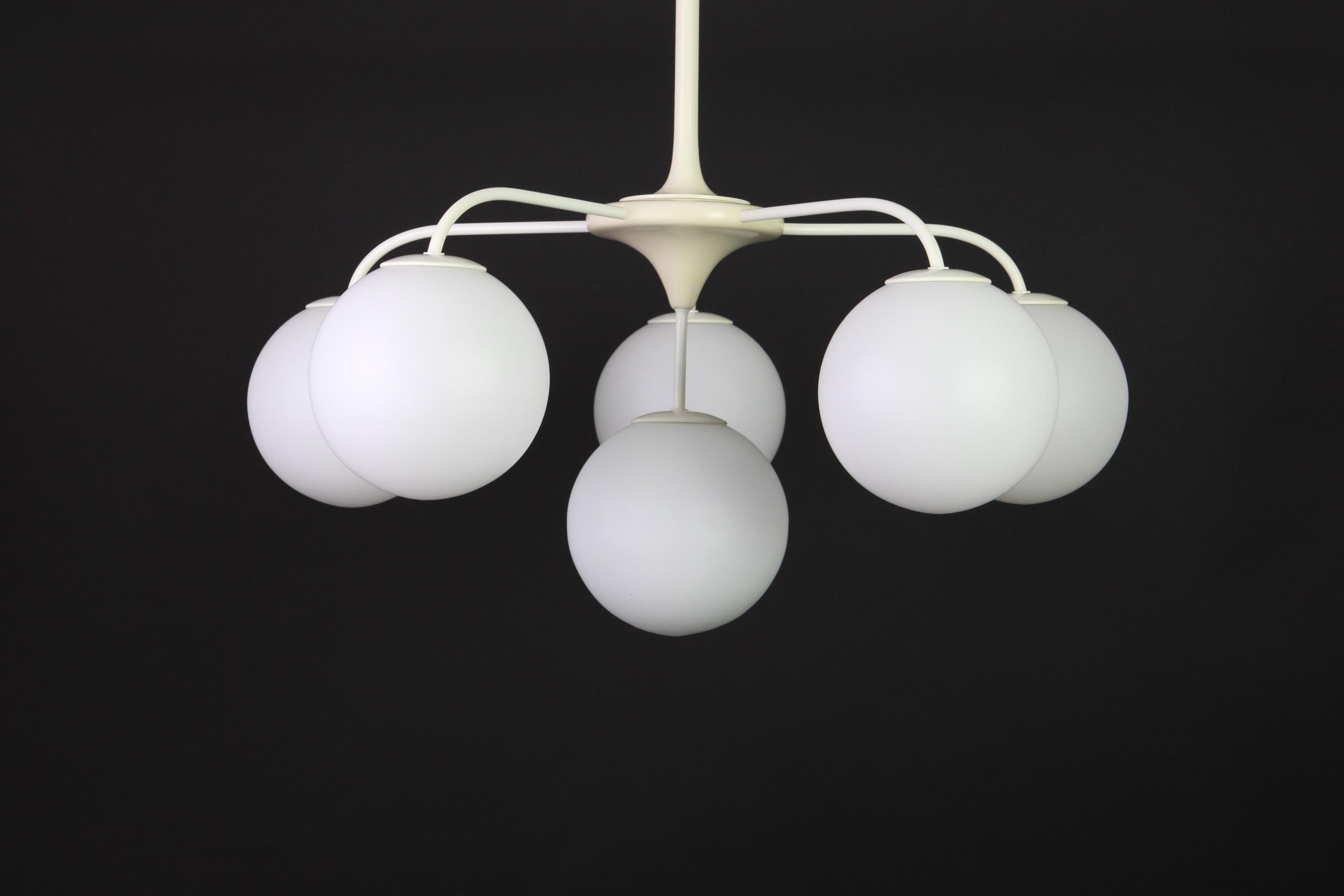 Atomic chandelier with six-glass globes was designed by the Swiss artist and designer Max Bill for Temde Leuchten. The globes are hand blown and fitted with a screwing device.

High quality and in very good condition. Cleaned, well-wired and ready