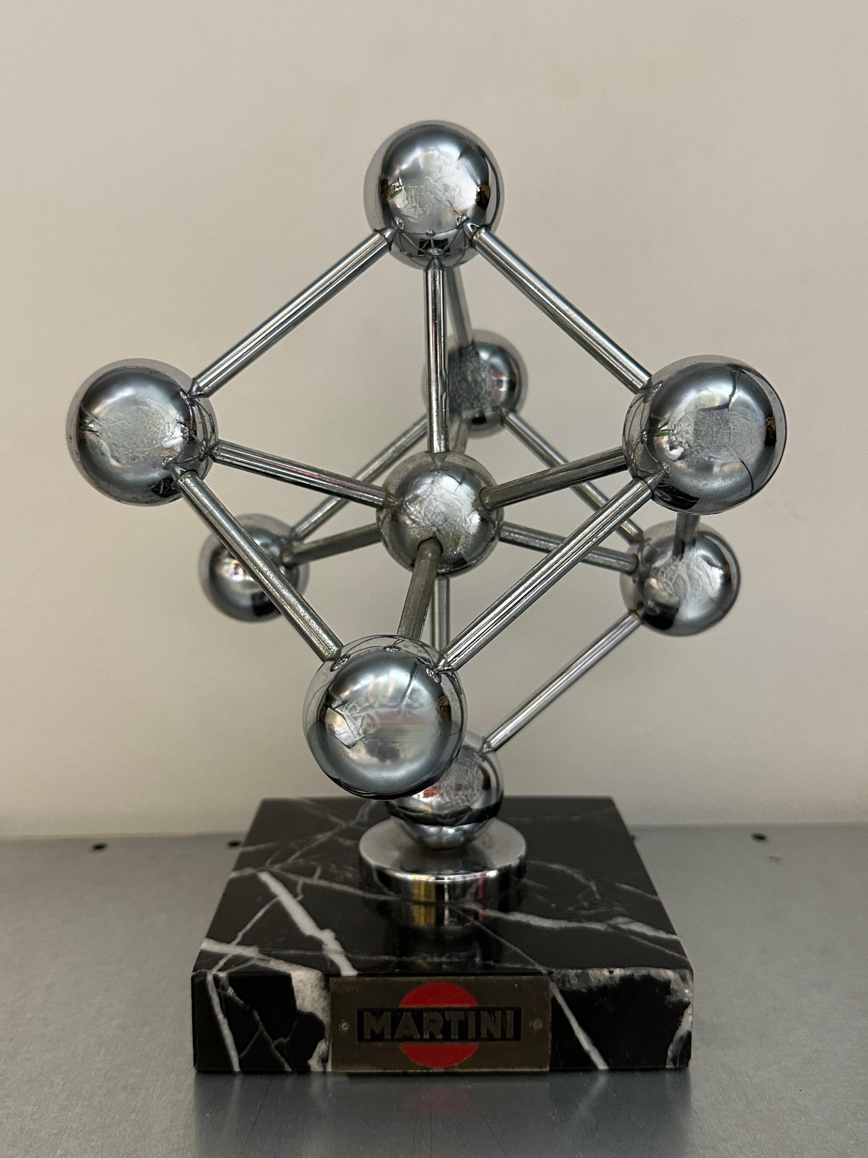 A decorative souvenir building sculpture. The Atomium is a landmark building in Brussels, Belgium, originally constructed for the 1958 Brussels World's Fair (Expo '58). This on is a large scale Martini Advertising Give Away. Very hard to find and