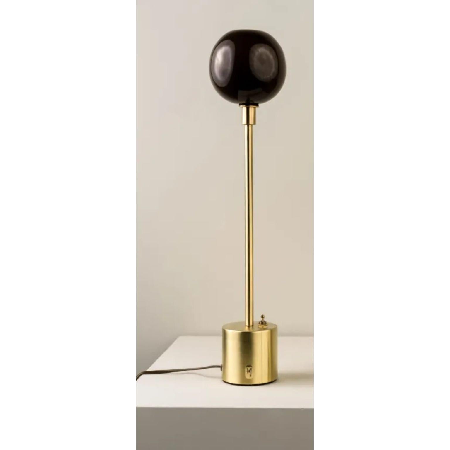 Átomo Coffee Blown Glass and Brass Table Lamp by Isabel Moncada
Dimensions: Ø 13 x H 33 cm.
Materials: Brass, steel and blown glass.

Átomo is perfect to give a touch of silent light, almost like a sparkle. The simplicity of its globe is enough, a