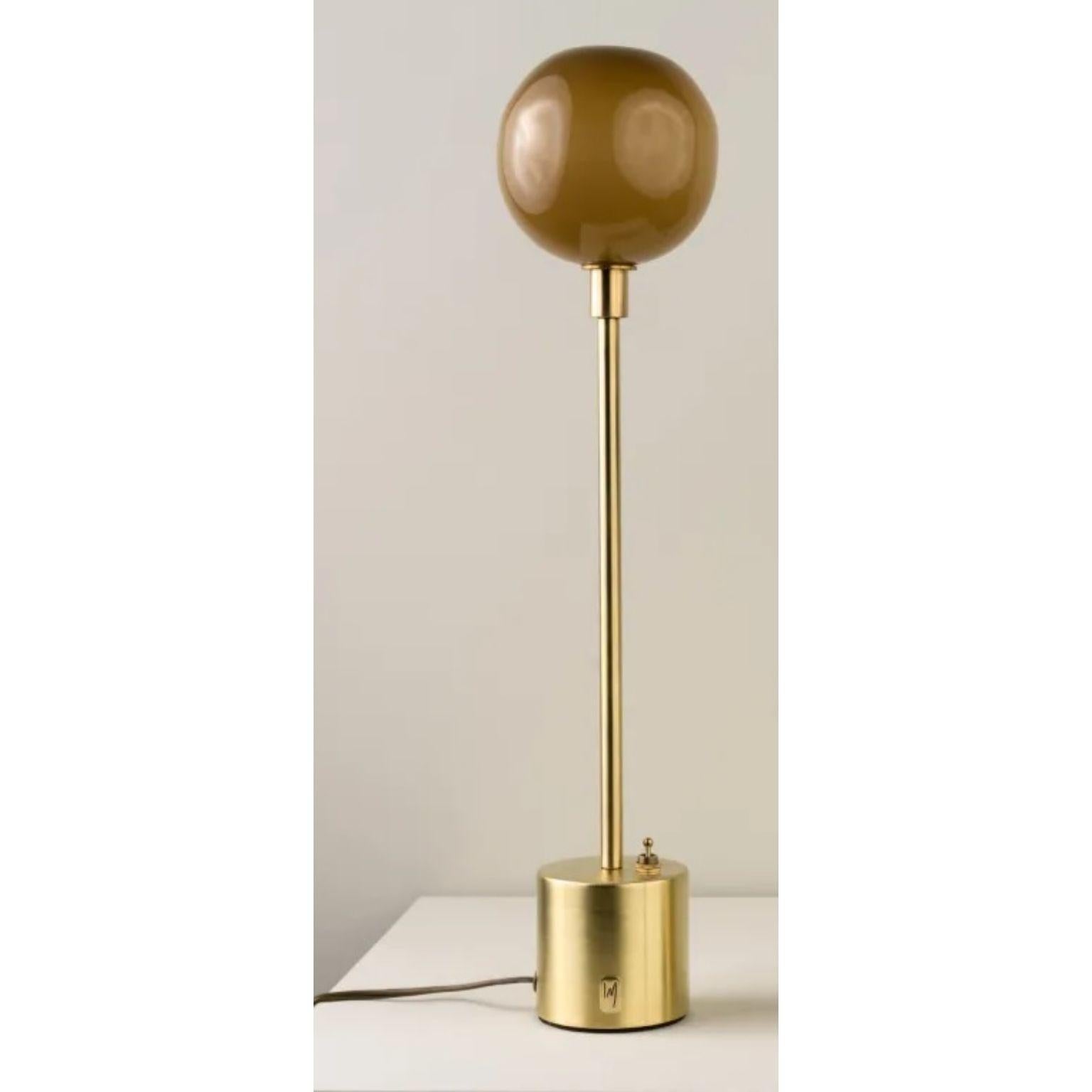 Átomo Sand Blown Glass and Brass Table Lamp by Isabel Moncada
Dimensions: Ø 13 x H 33 cm.
Materials: Brass, steel and blown glass.

Átomo is perfect to give a touch of silent light, almost like a sparkle. The simplicity of its globe is enough, a