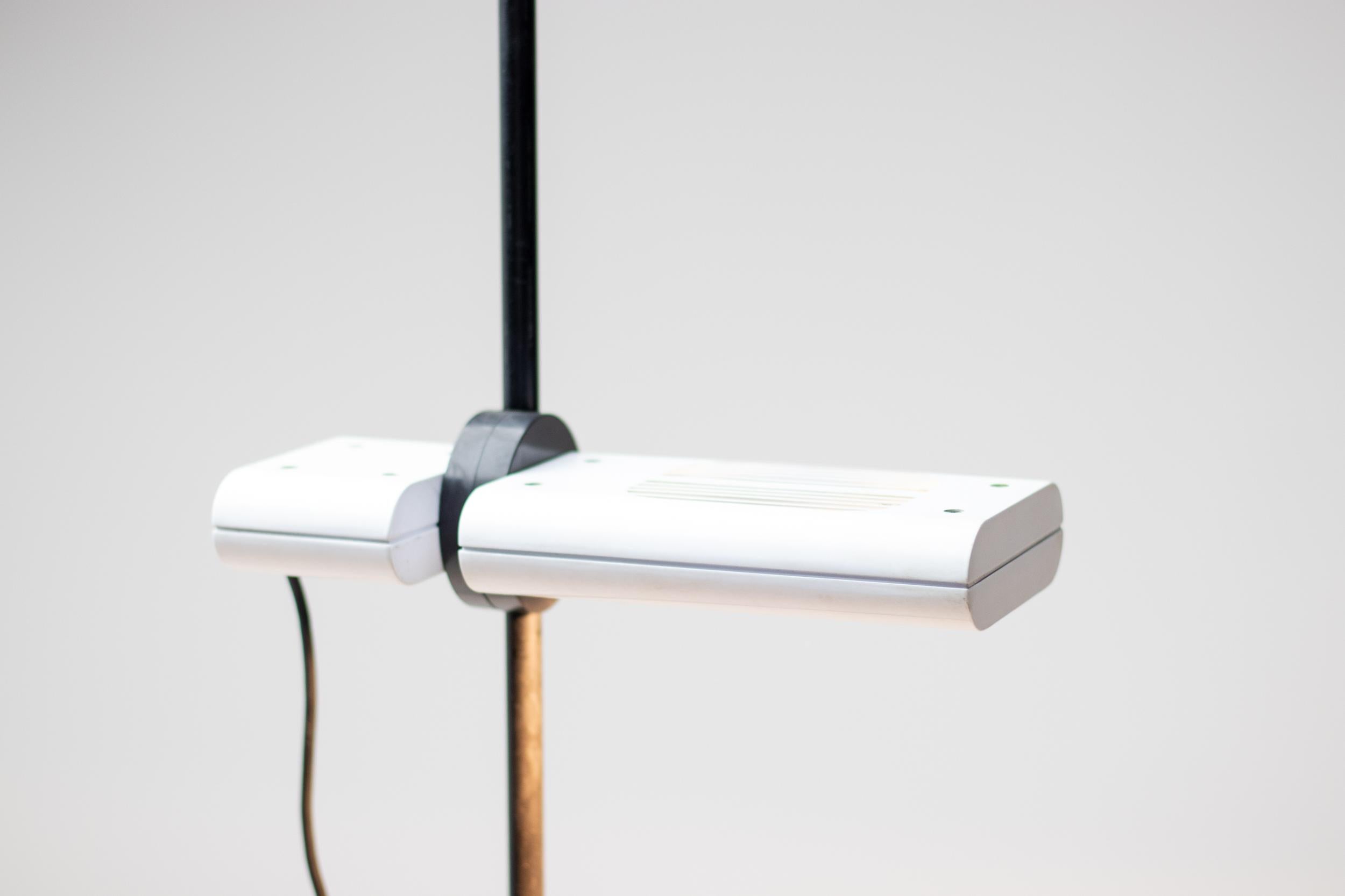 Minimalist Aton Terra halogen floor lamp designed by Ernesto Gismondi for Artemide, Italy. Marked underneath the base. Currently out of production. Features a height adjustable shade that can be used as an uplighter or downlighter.  Excellent