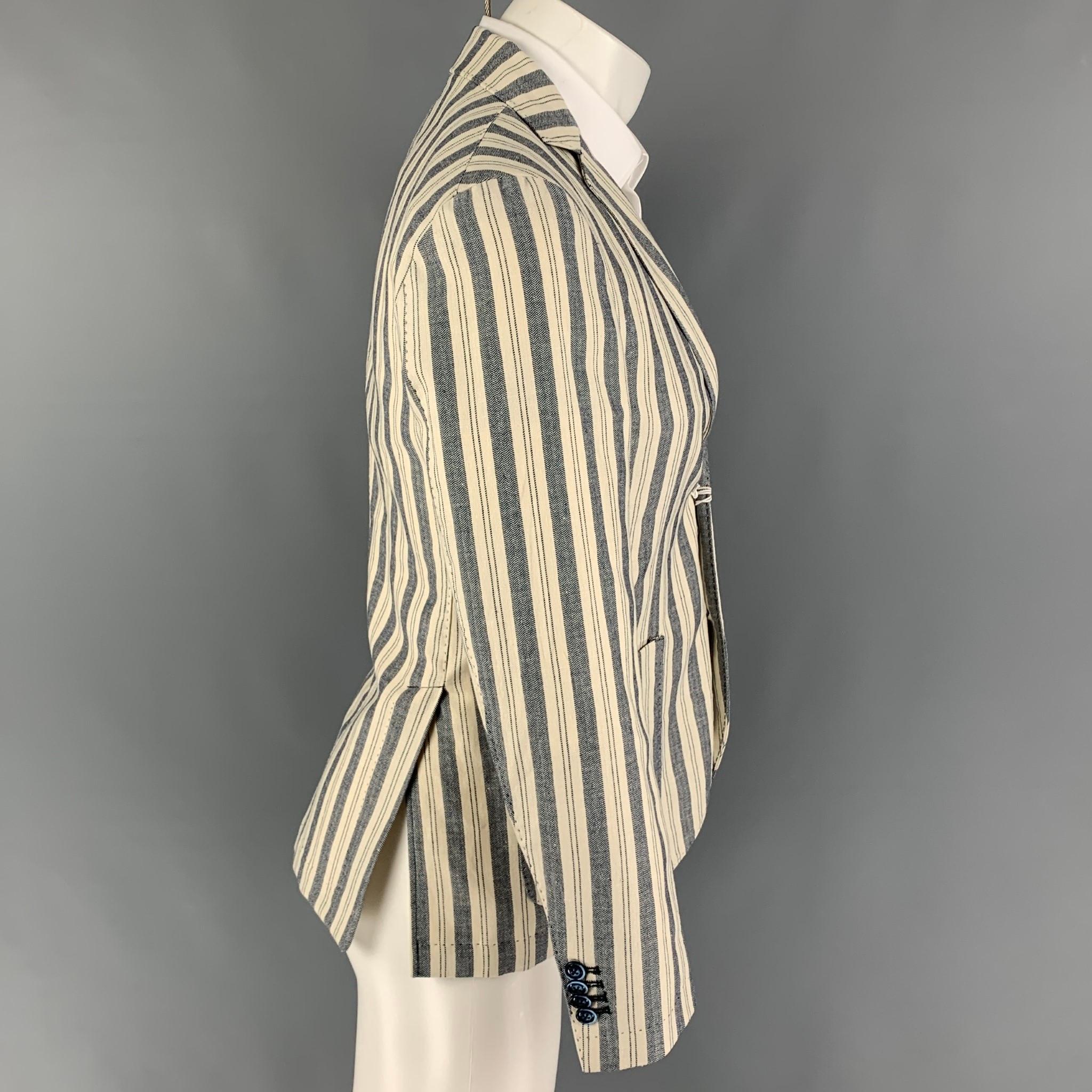 AT.P.CO sport coat comes in a beige & navy stripe cotton / linen featuring a notch lapel, patch pockets, double back vent, and a double button closure. 

New with tags. 
Marked: 46

Measurements:

Shoulder: 16.5 in.
Chest: 36 in.
Sleeve: 24.5