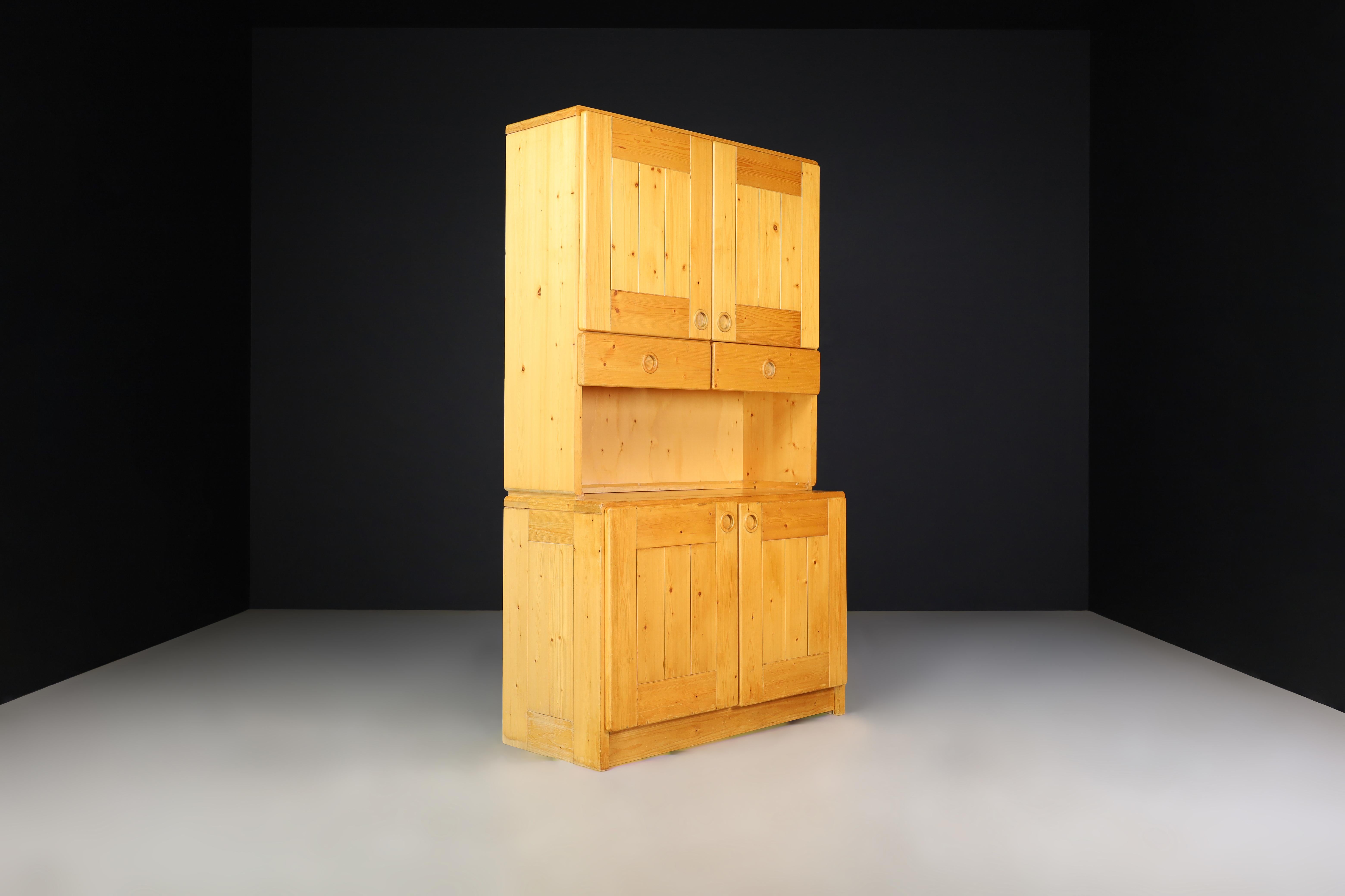 Att. Charlotte Perriand pine cabinet for Les Arcs, France 1970s

This is a description of a pine cabinet attributed to Charlotte Perriand for Les Arcs in the 1970s. The cabinet has four doors and two pull-out drawers, and it is made of solid pine.