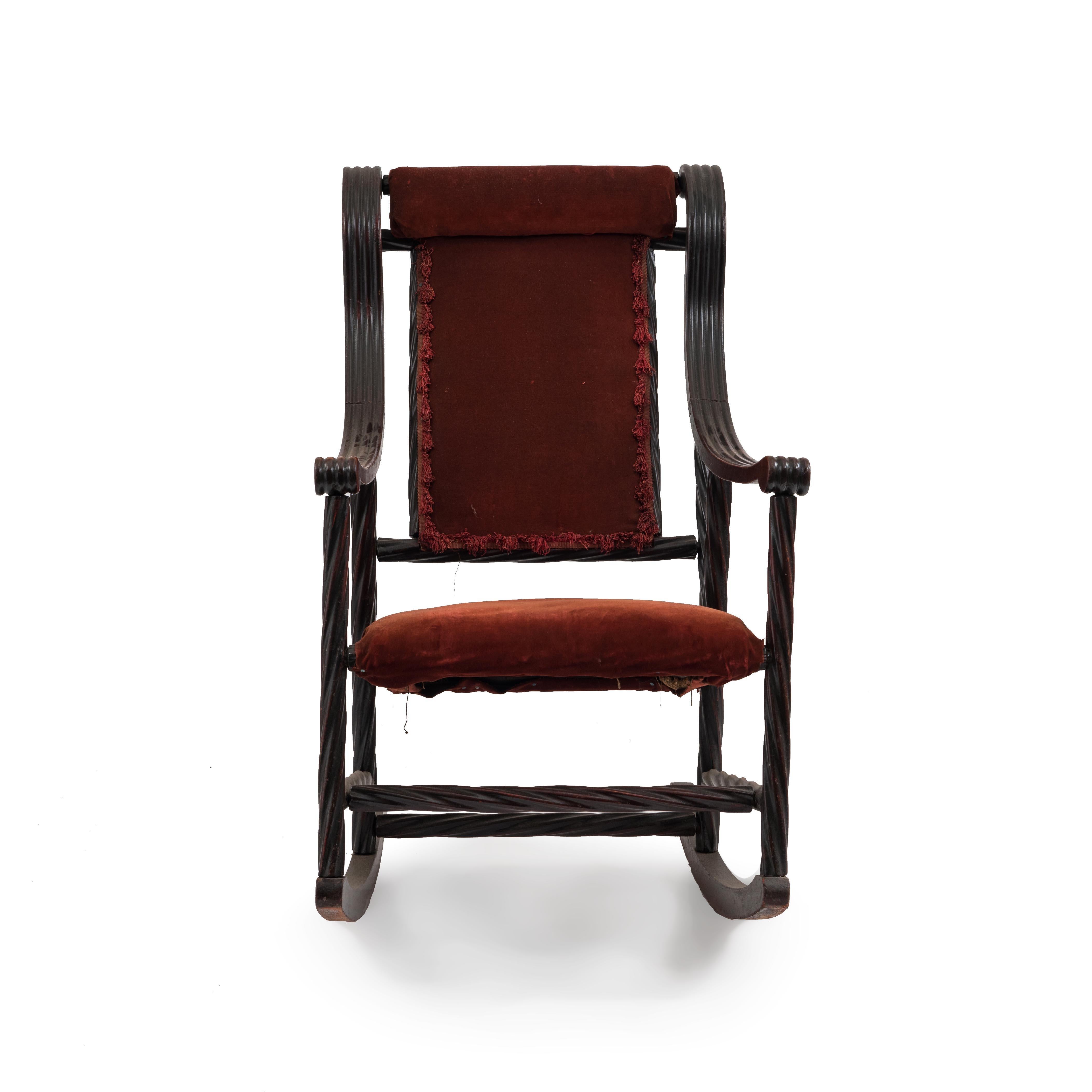 American Victorian walnut swirl design rocking chair with red velvet seat and back. (att: Hunzinger).