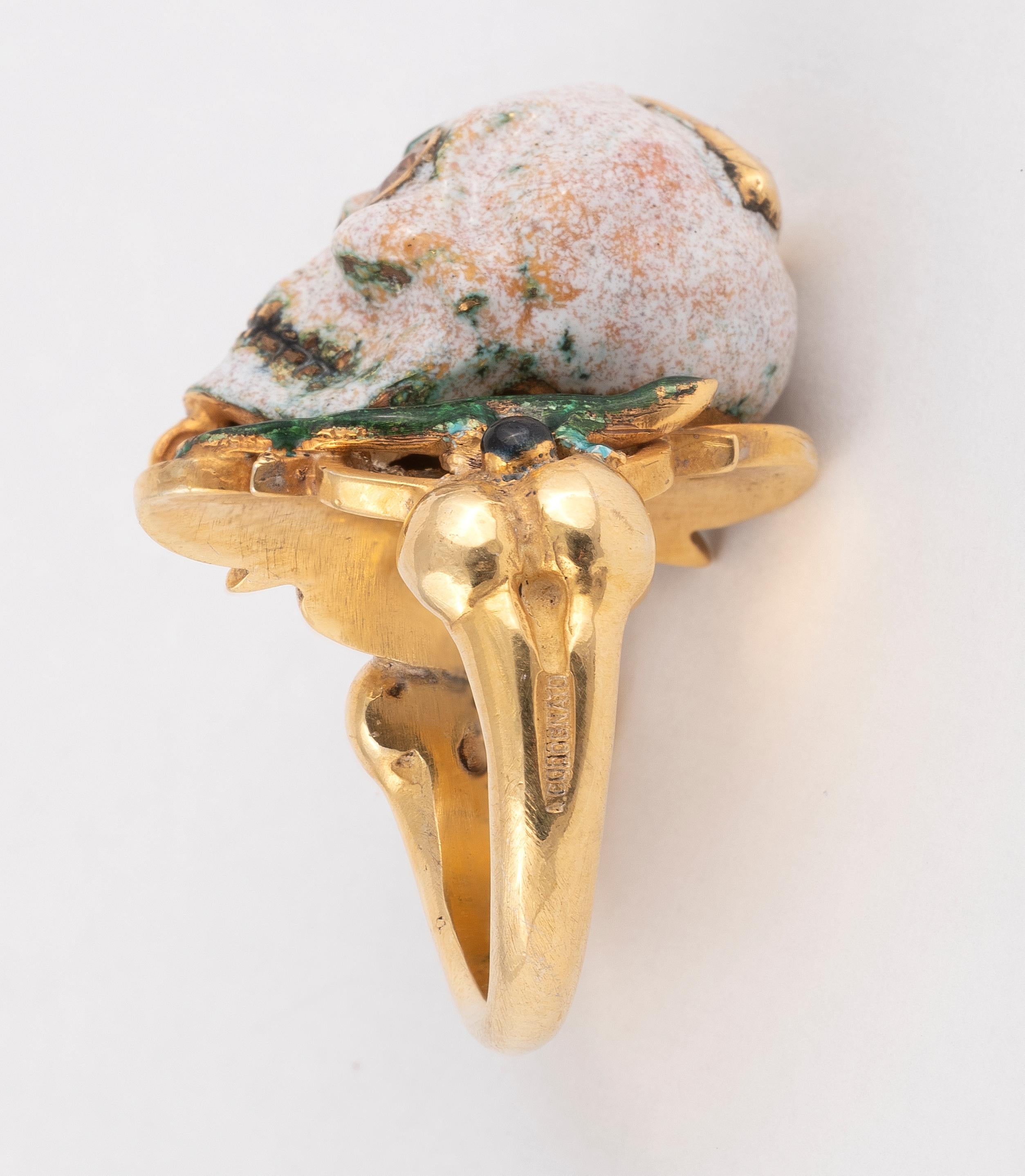 The Renaissance style Memento Mori skull with a lizard ring made with champleve multicolored enamels, round cut diamonds eyes and pear cut diamond at the top.

Mounted in 18Kt yellow gold

Size 7 1/2

Signed A. Codognato Venezia

Weight: 25.2