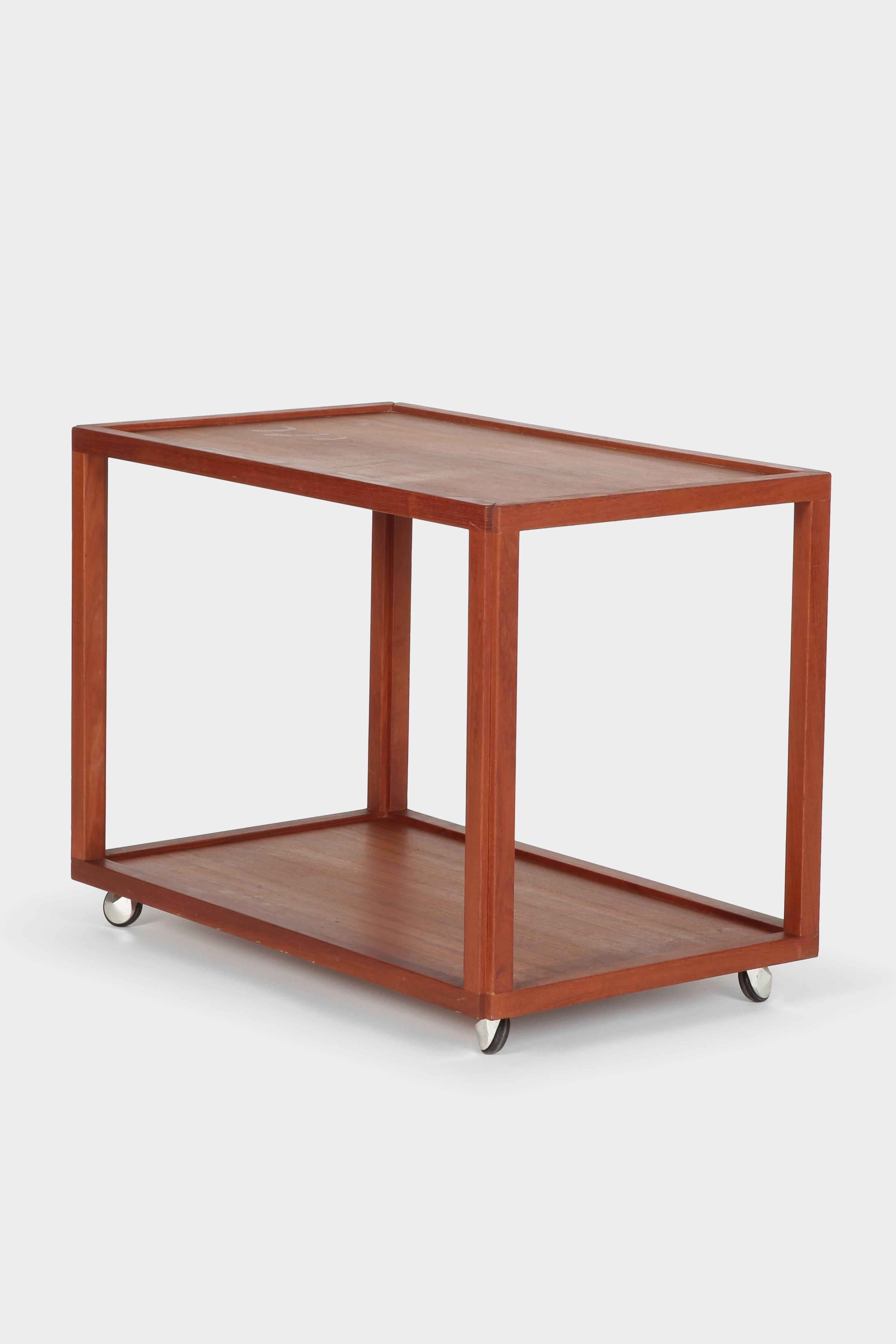 Attributed to Aksel Kjersgaard bar cart manufactured in the 1950s in Denmark. Solid and beautiful processed teak wood. Very modern and minimalist design.