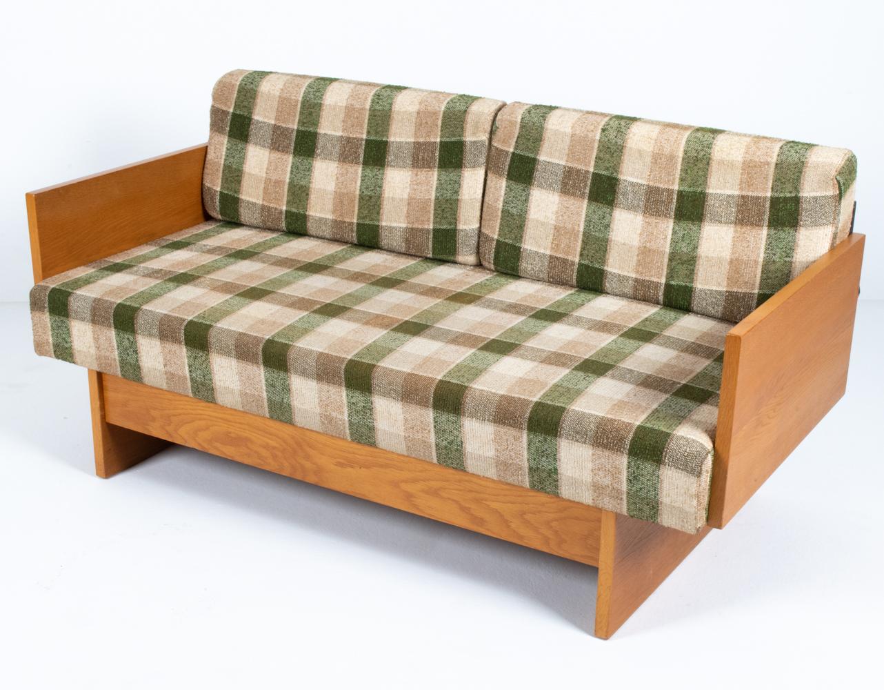 Take relaxation to a new level of style with this Danish mid-century convertible sofa/daybed. Attributed to iconic 20th century Danish designer Borge Mogensen, this sofa features a minimalist wooden frame in sturdy oak with plaid cushions. Fold down