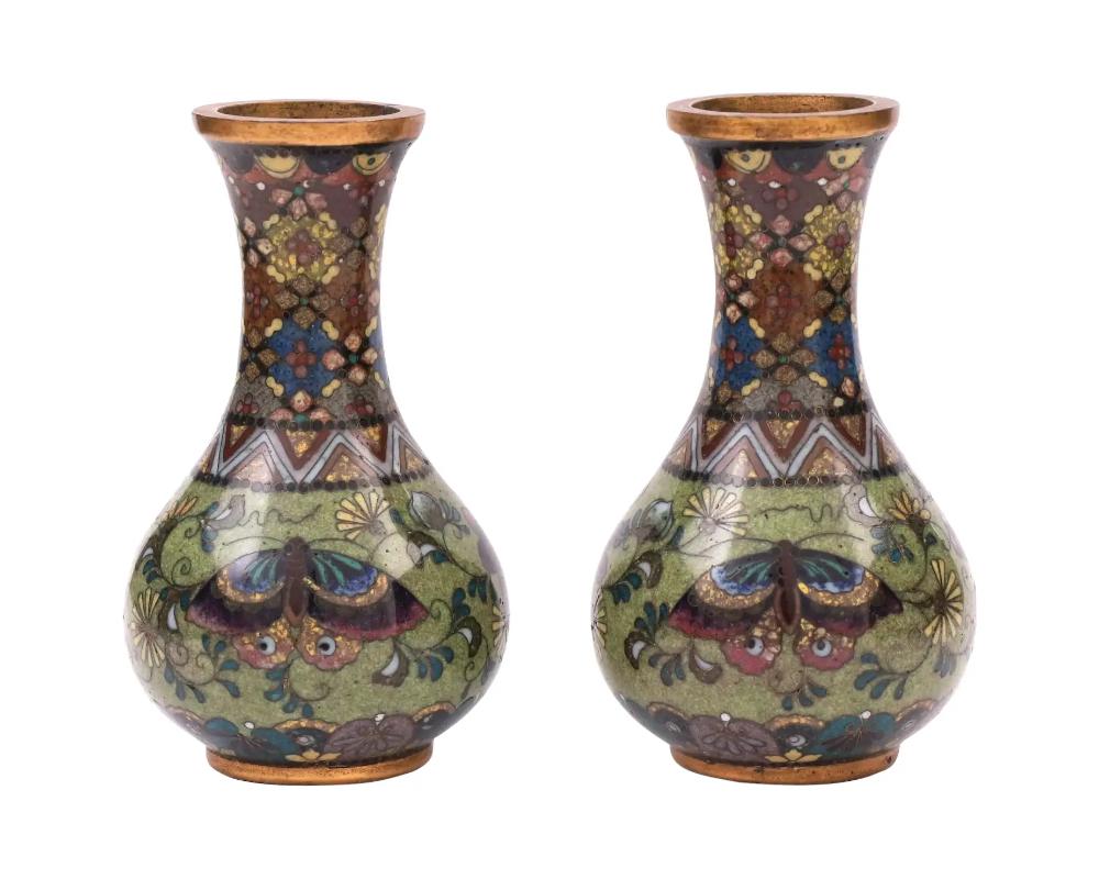 Attributed to Namikawa Yasuyuki, 1845 to 1927, a pair of rare identical antique Japanese, late Meiji era, enamel vases. Each vase has a globular shaped body and a long fluted neck. The bodies of the vases are adorned with polychrome images of