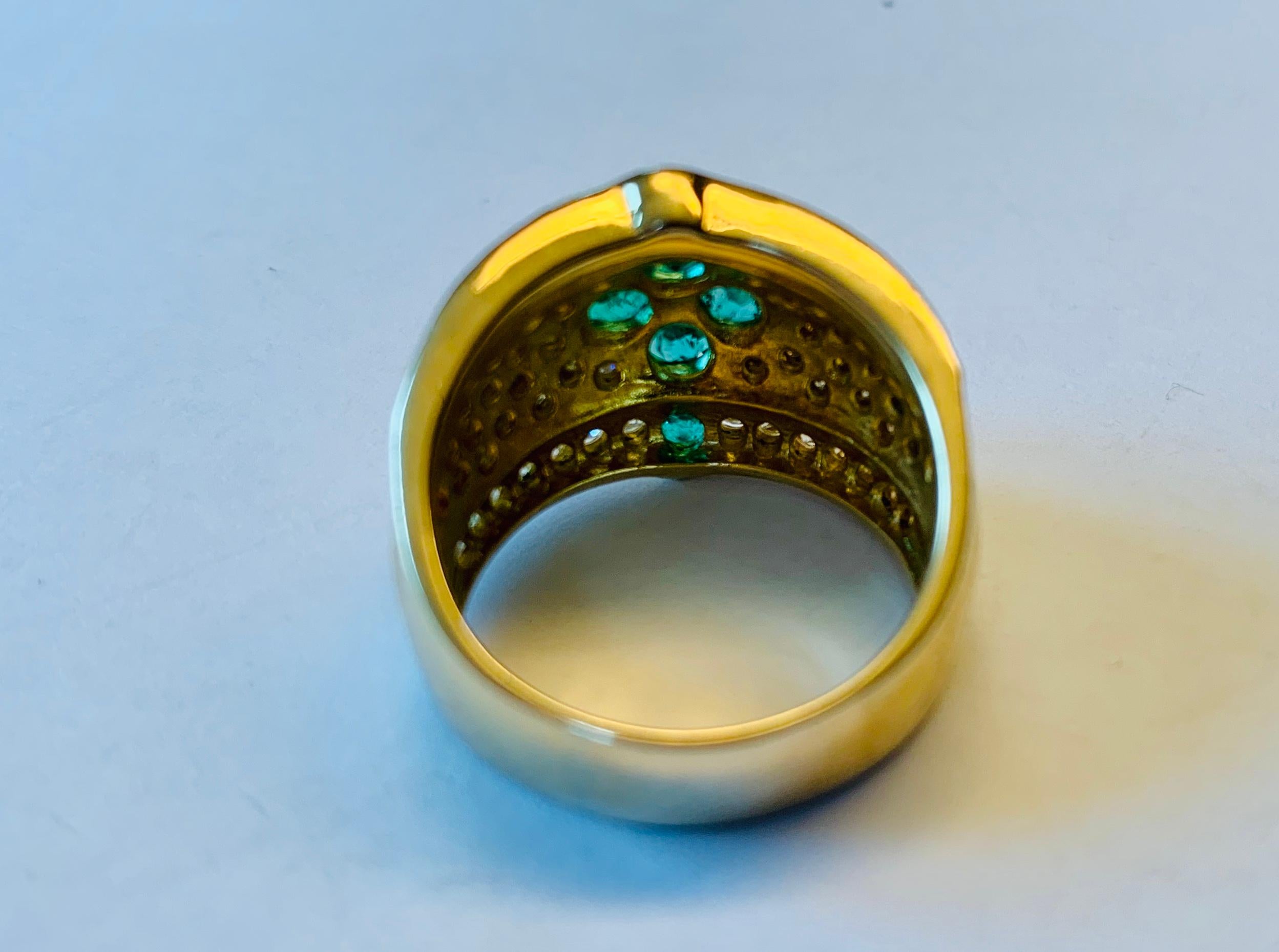 Very unusual and attractive 18 yellow Gold ring set with nice diamonds weighing approximately 1.06 ct and vivid green emealds weighing approximately 1.01 ct. 

The ring is currently size 52/12 but can be resized larger or smaller if necessary.
