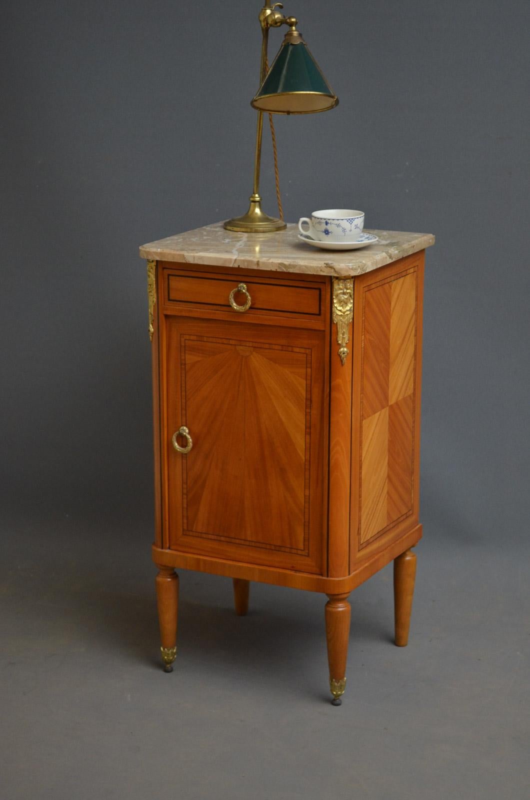 Sn2816, an attractive Continental, bedside cabinet with marble top, having molded edge, single drawer below with ebony inlaid edge and satinwood sunray inlaid cupboard, all fitted with original brass handles and crossbanded throughout, decorative
