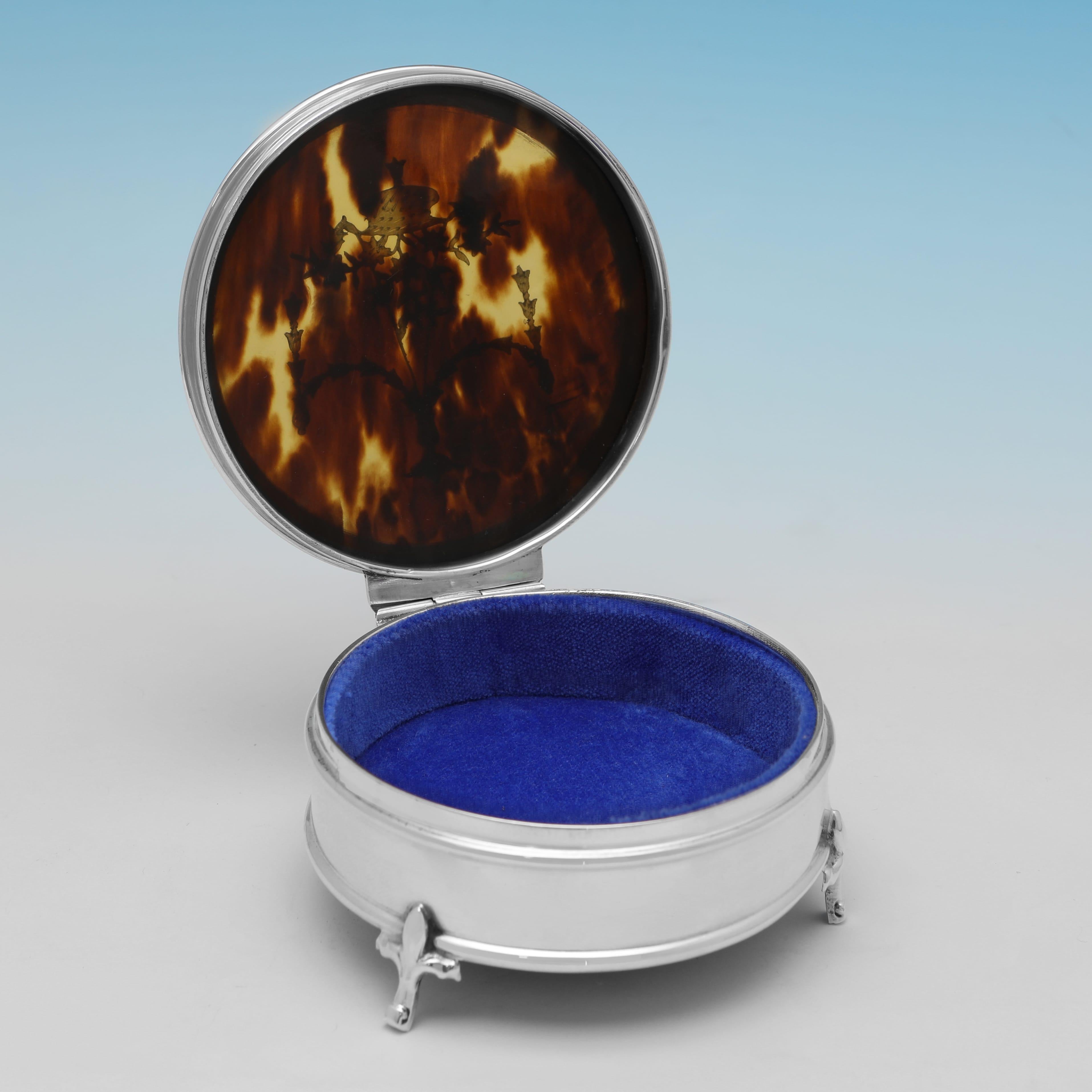 Hallmarked in Birmingham in 1911 by Mappin & Webb, this attractive, Antique Sterling Silver Jewellery Box, features a Tortoiseshell lid with silver inlay, reed borders, and a blue fabric lined interior. The jewellery box measures 1.75