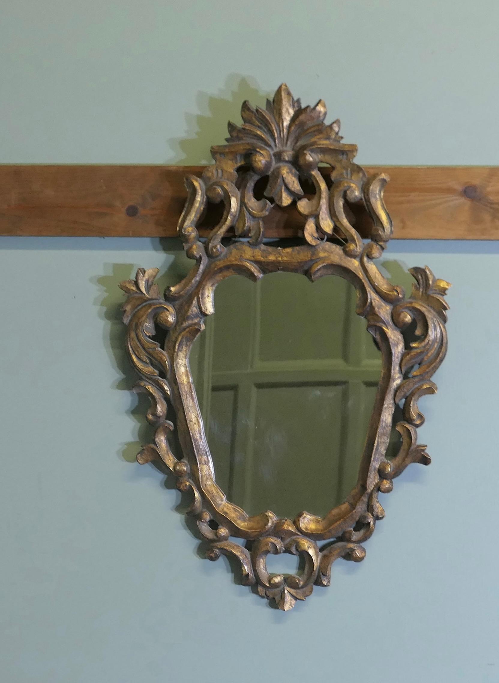 Attractive Baroque Style Small Gilt Wall Mirror

The Mirror has an unusual shape, it has an elaborate wide carved gilt Frame in the Italian Baroque Style, there are abundant Scroll and leaf decoration all around the frame
A Wonderfull addition to