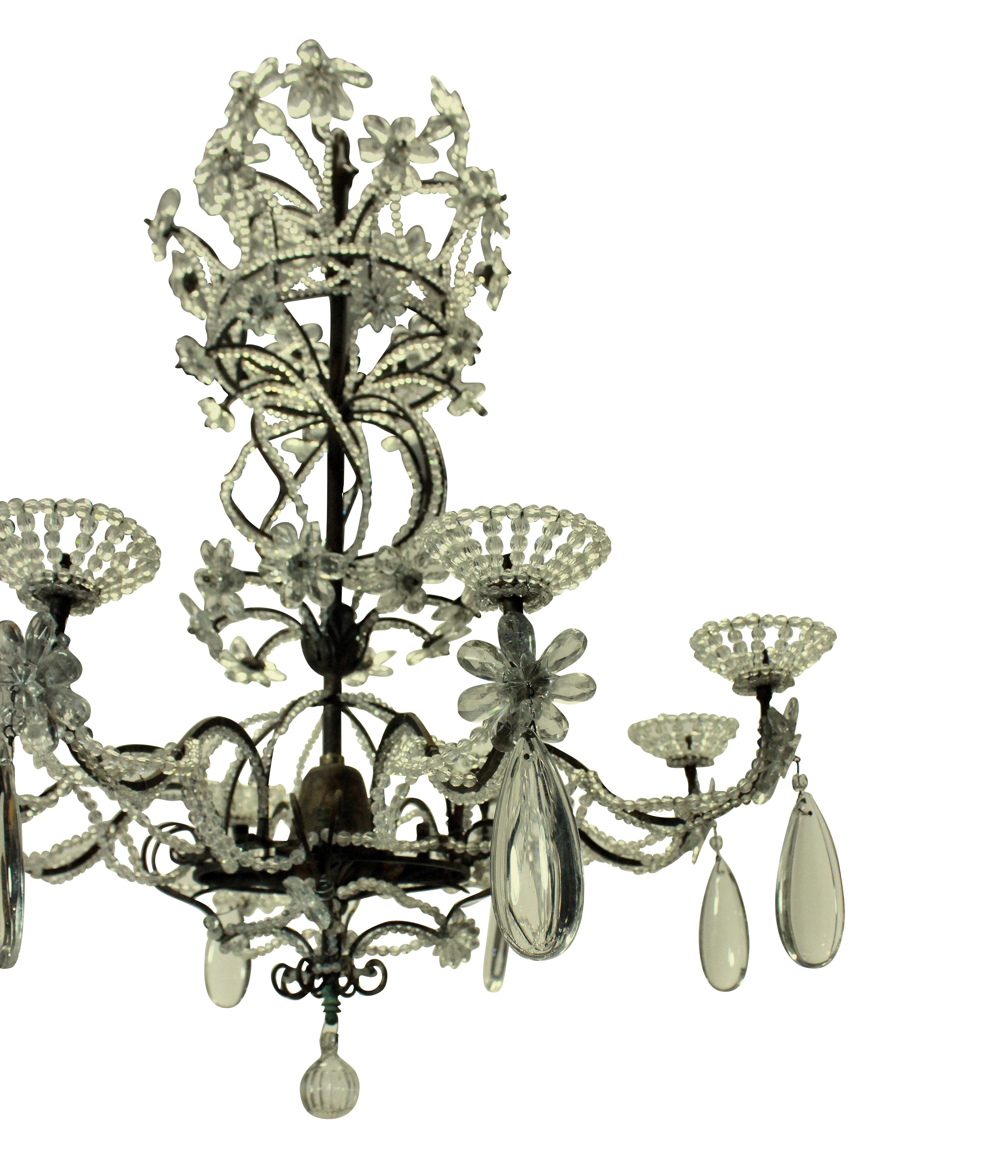 A Genoese chandelier of attractive design, in bronze, iron and hung throughout with glass beads and flowers. (Needs electrifying).