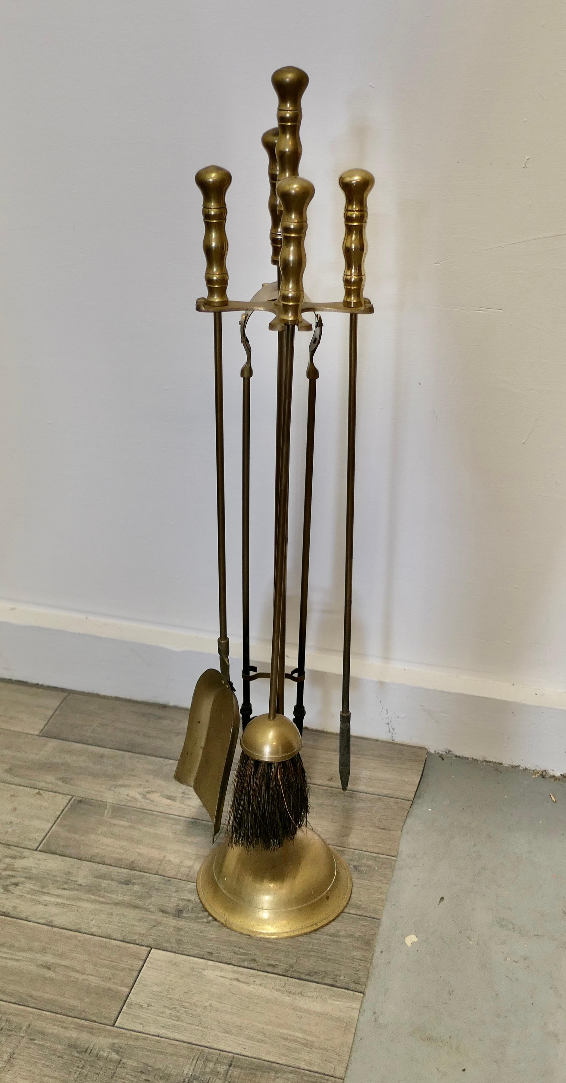Attractive brass Fireside Companion set, fireside tools

This is a long handled set on its own stand, shovel, tongs, brush and poker 
The stand 30” tall and 7” in diameter
CC228.
  