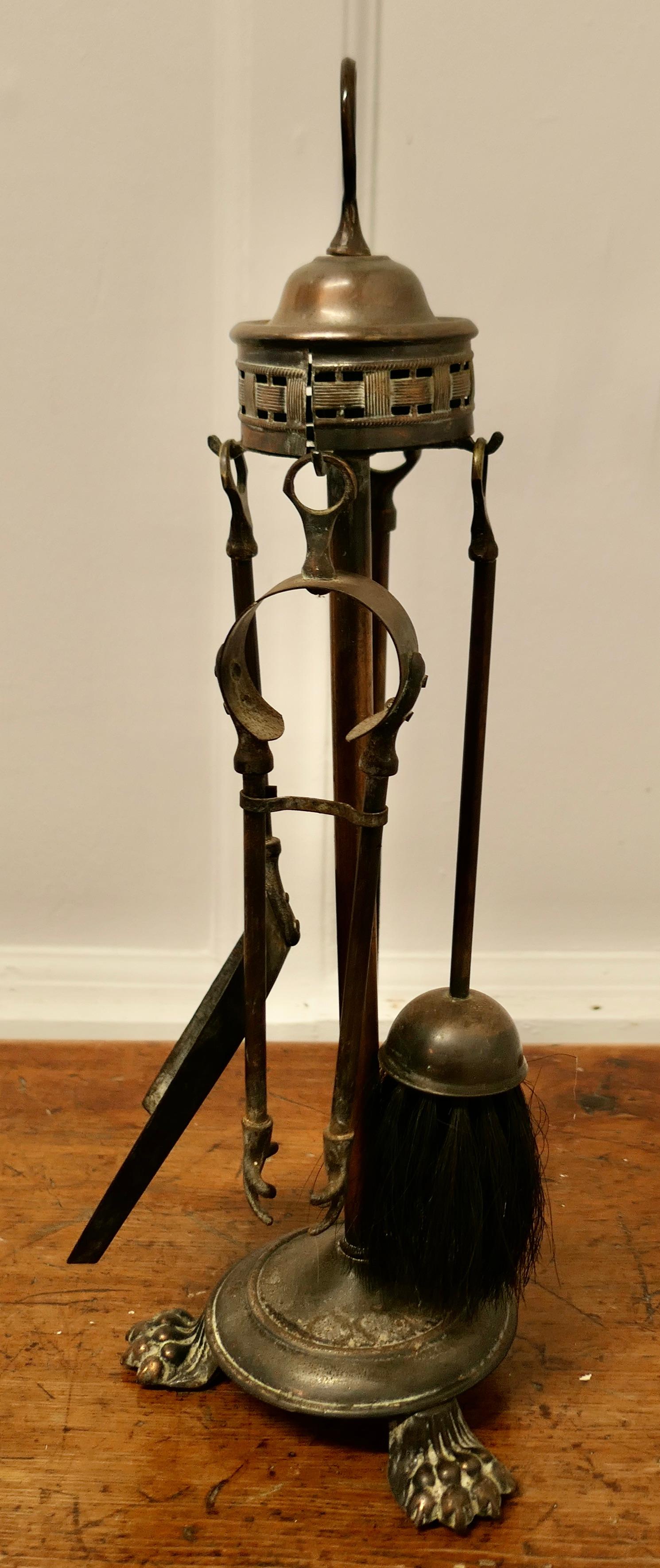 Attractive Brass Fireside Companion Set, Fireside Tools

This is a oxidised copper and brass set on its own stand, shovel, tongs, brush and poker  
The stand 21” tall and 7” in diameter
TSW148
