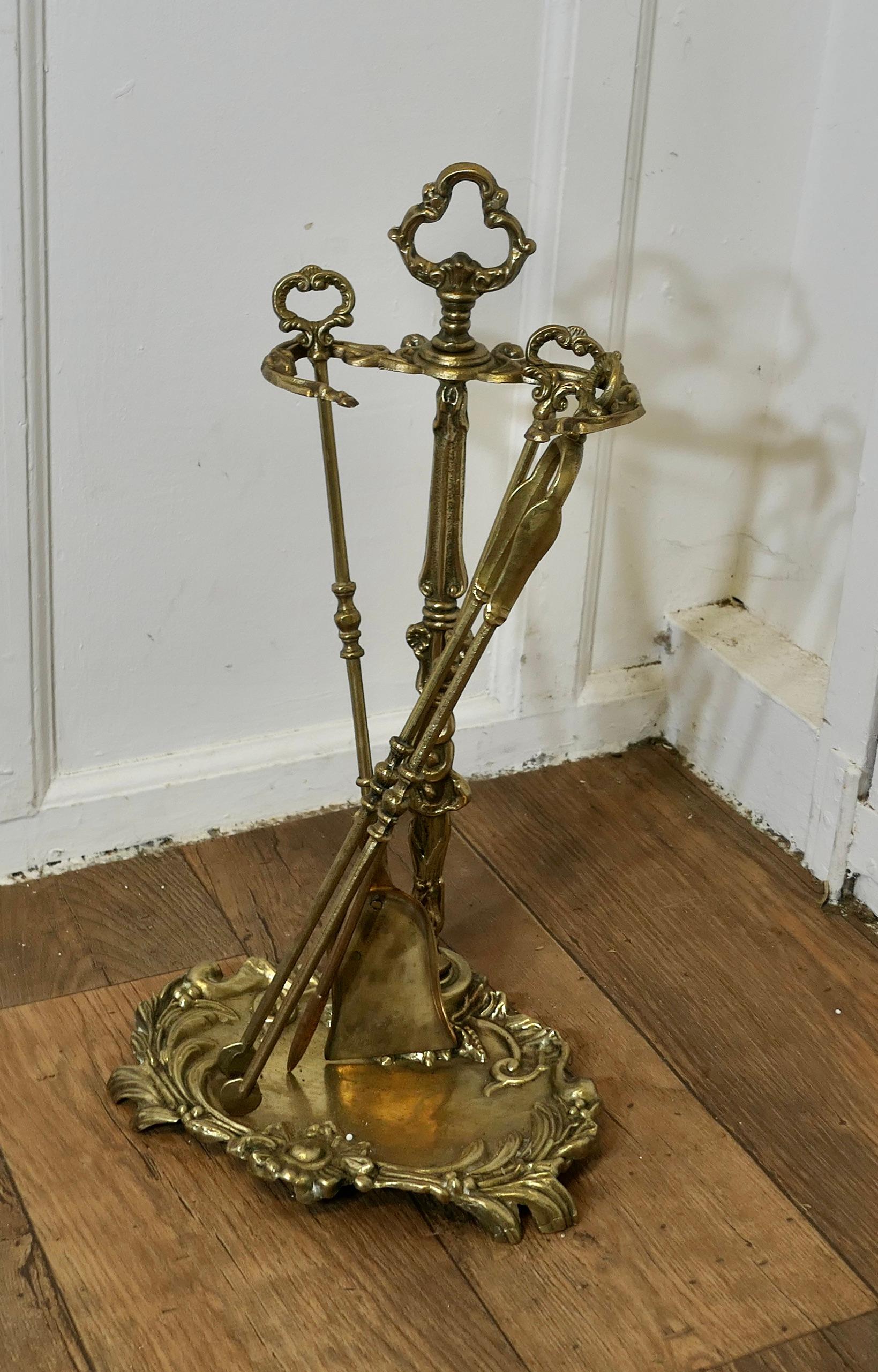 Attractive Brass Rococo Style Fireside Companion Set, Fireside Tools

This is a very attractive set on its own stand, shovel, tongs, and poker with wonderful Decorative style to the handles and the base of the stand
The stand 22” tall and 12” x