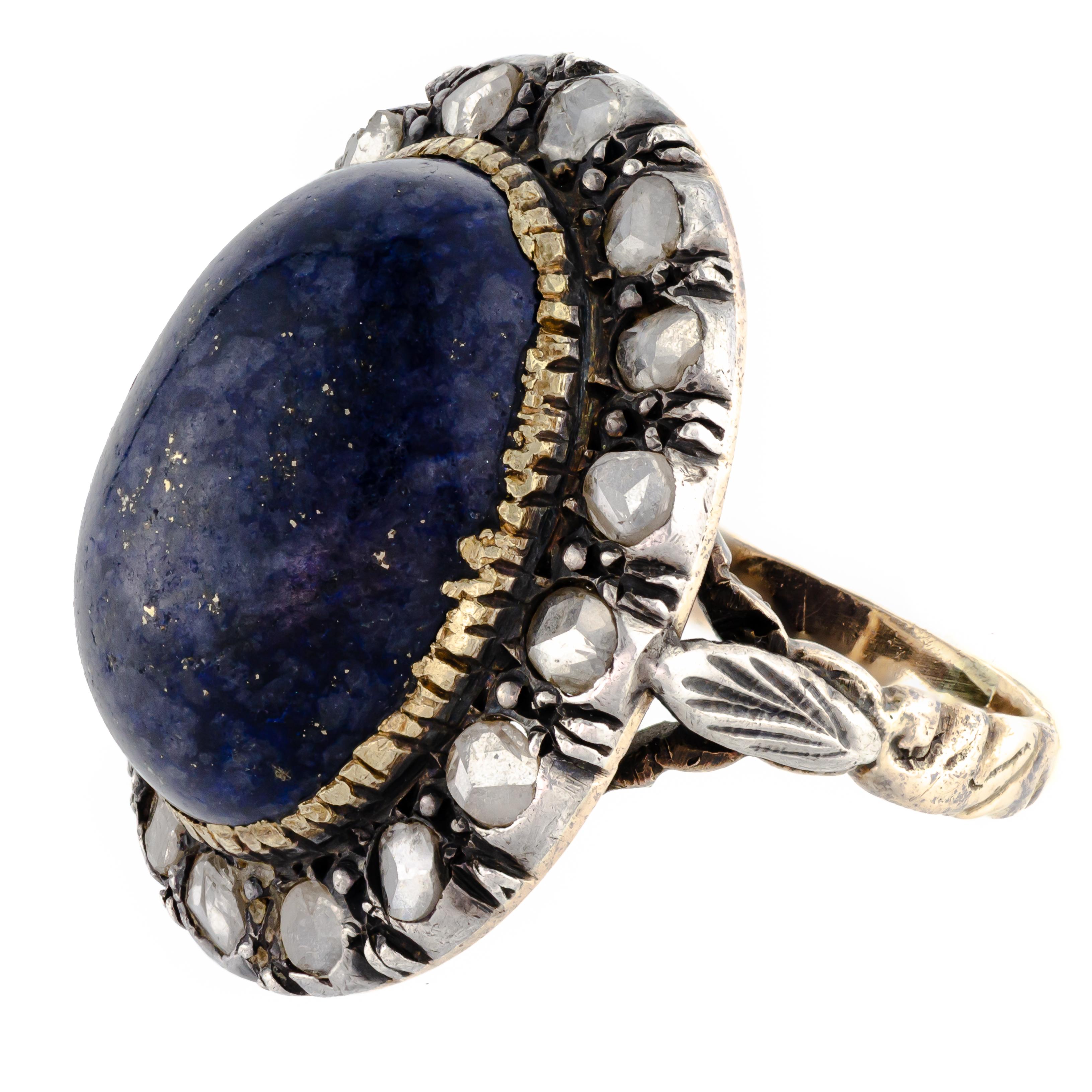 Attractive circa 1915 lapis and rosecut diamond ring centrally set with one (1) oval cabochon measuring approximately 18 x 12.5mm framed by 16 rosecut diamonds - unmarked but tested bicolor mount of silver (diamonds set in silver as was the style)