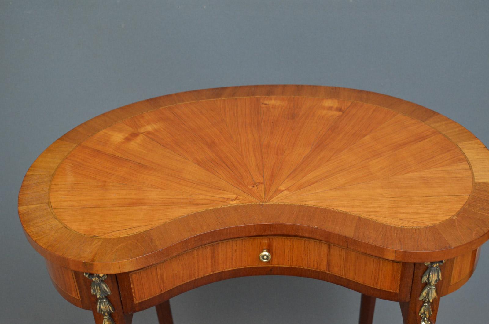 Sn3880, An attractive Continental, kidney shaped occasional table in satinwood, having segmented top and inlaid frieze with practical drawer flanked by ormolu raise on slender cabriole legs with brass sabots. This stunning occasional / lamp table is