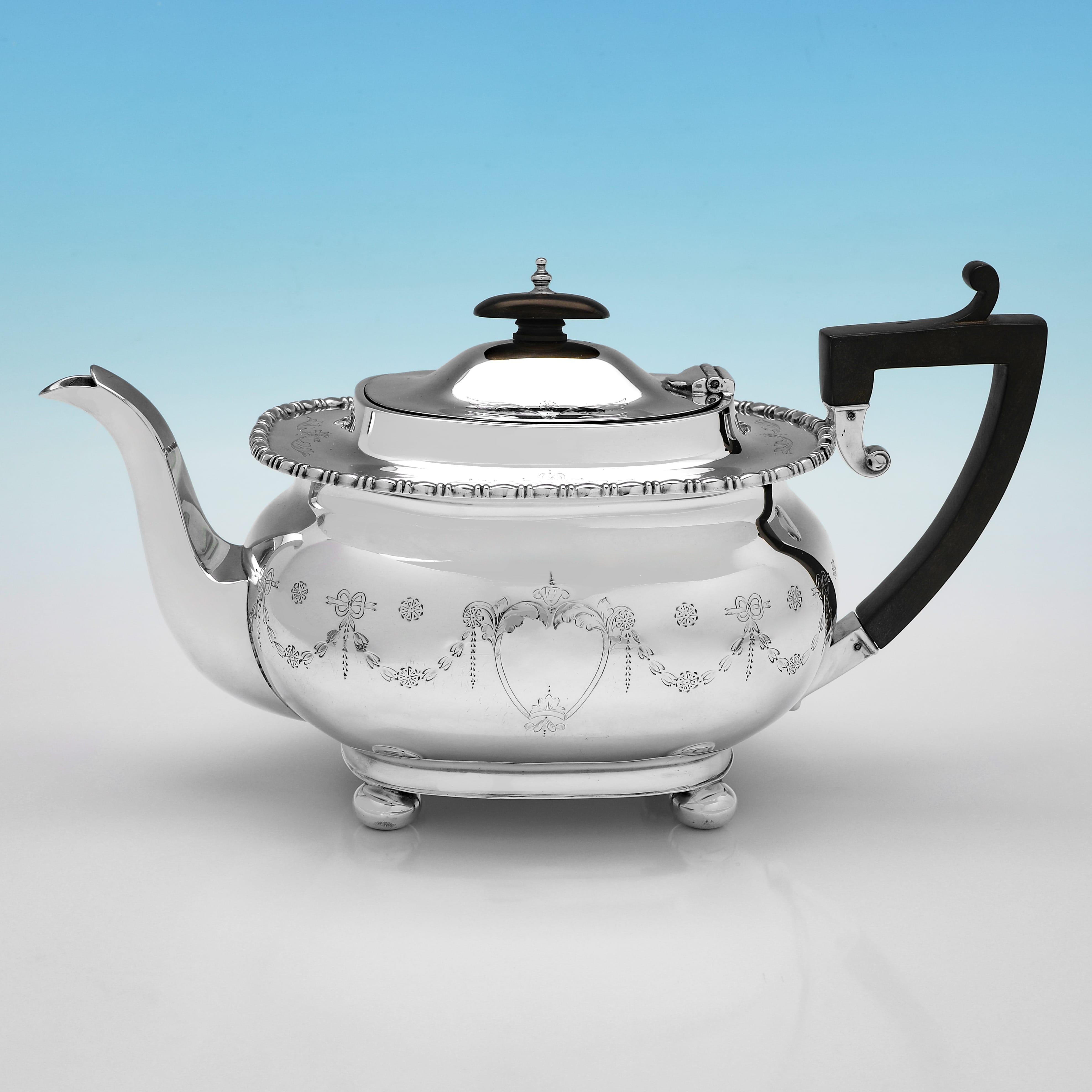 Hallmarked in Sheffield in 1912 by J. Parkes & Co., this attractive, Antique Sterling Silver Tea Set, stands on ball feet, and features swag and bow engraving throughout. The set together weigh 68 troy ounces.
 
The teapot measures 6