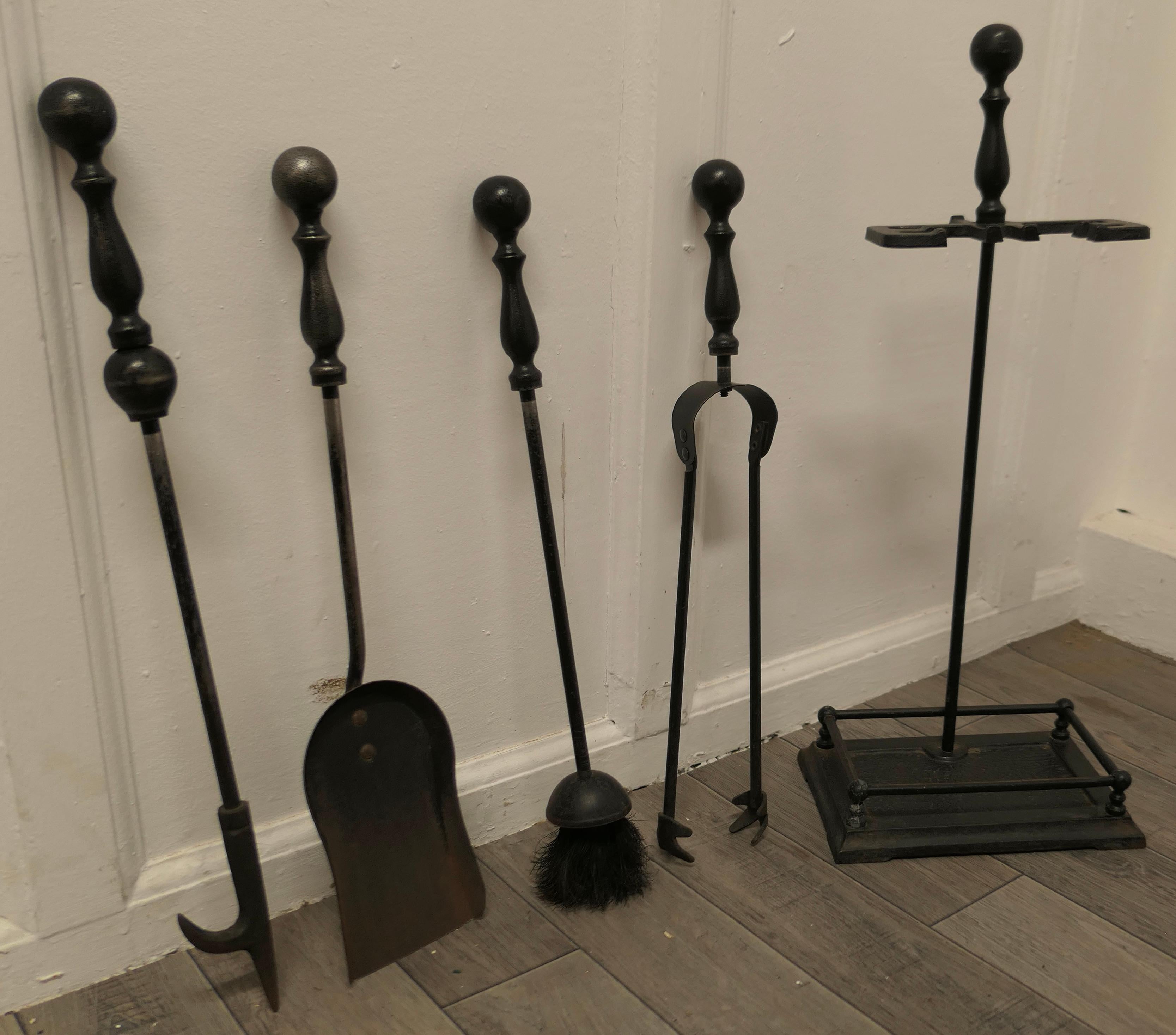 Attractive Gothic style fireside companion set, fireside tools

This is an attractive set on its own stand, brush, shovel, tongs, and hook poker all set on a heavy stand
The stand 22” tall, 10” across at the floor and 6” deep
TJK191.