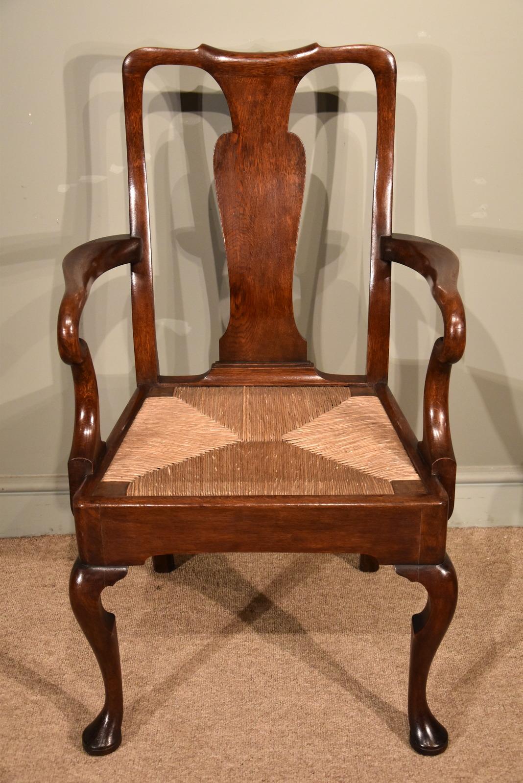 An attractive set of eight George II oak dining chairs with rush seats. The chairs with vase shaped splats and elegant cabriole legs and pad feet the two carvers are possibly later in origin maybe 19th century.

Dimensions: Single chair
Height