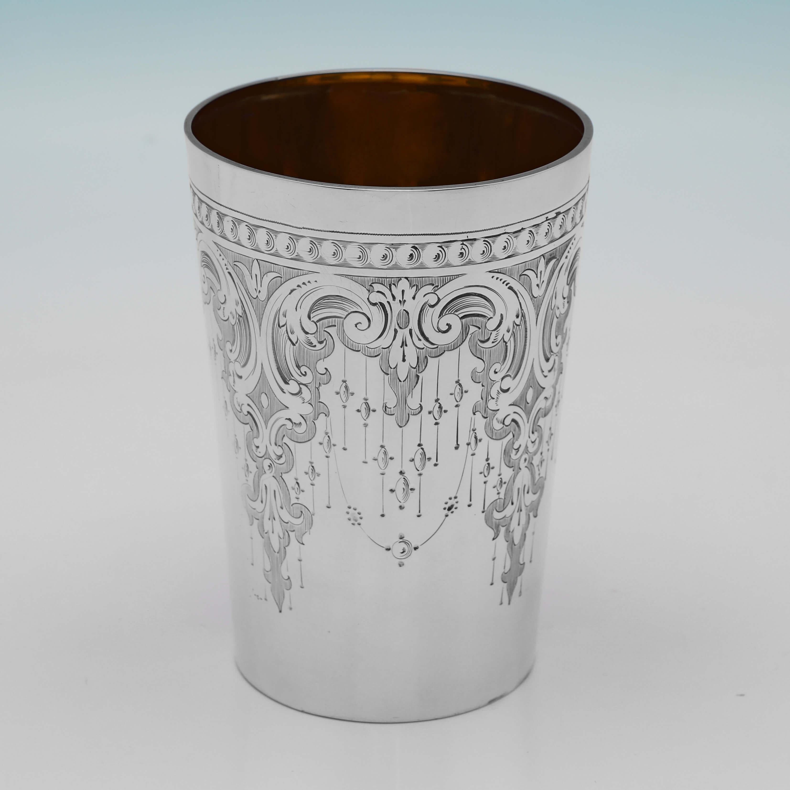 Hallmarked in London in 1872 by Henry John Lias & Son, this very attractive, Victorian, Antique Sterling Silver Beaker, features wonderfully engraved decoration throughout and a gilt interior. The beaker measures 4.5