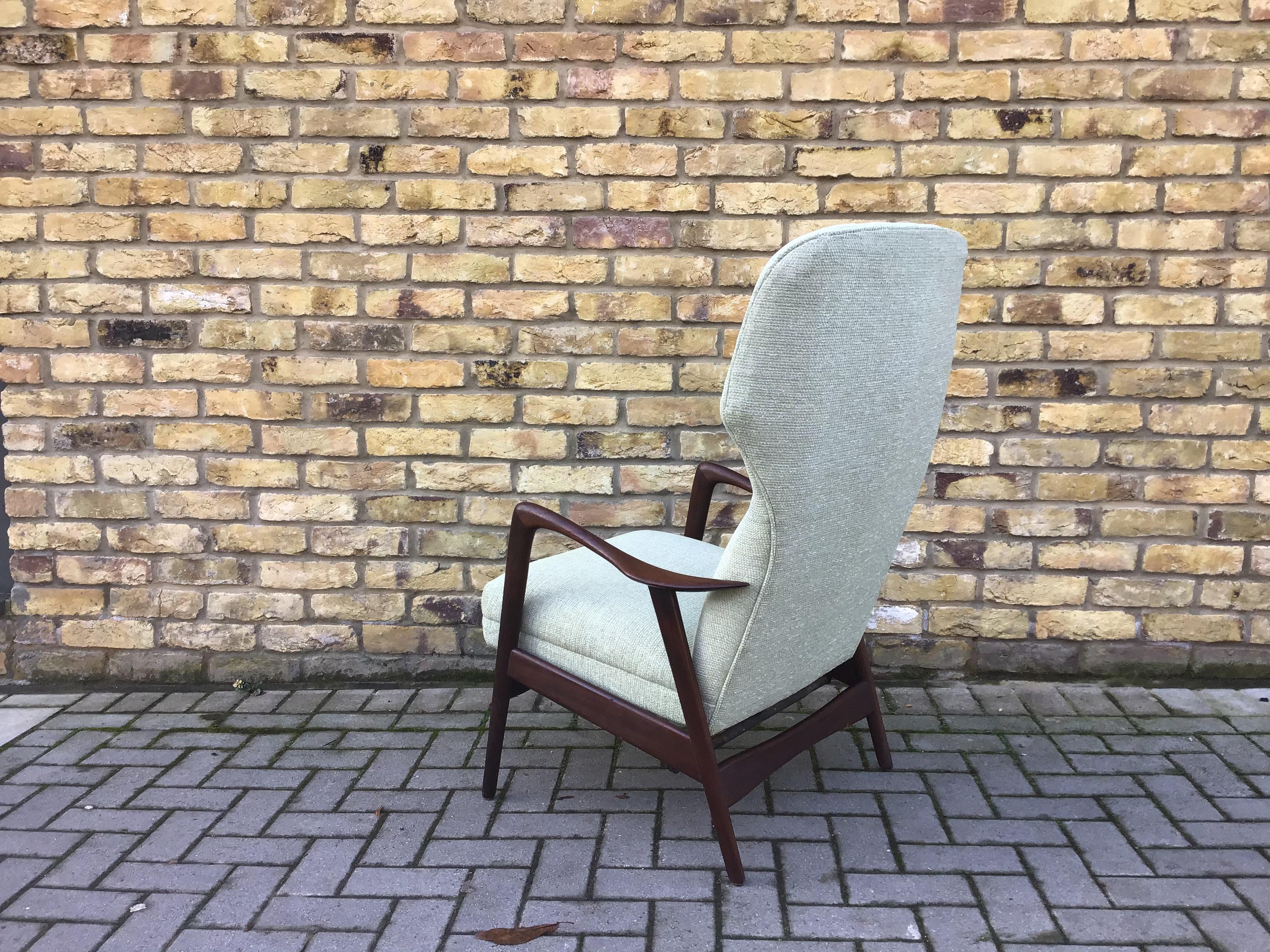 Gorgeous armchair reupholstered in pale green woolen fabric 
High chair with function to make it into a rocker unusual item
Attribute to Aksel Bender Madsen, circa 1960s.