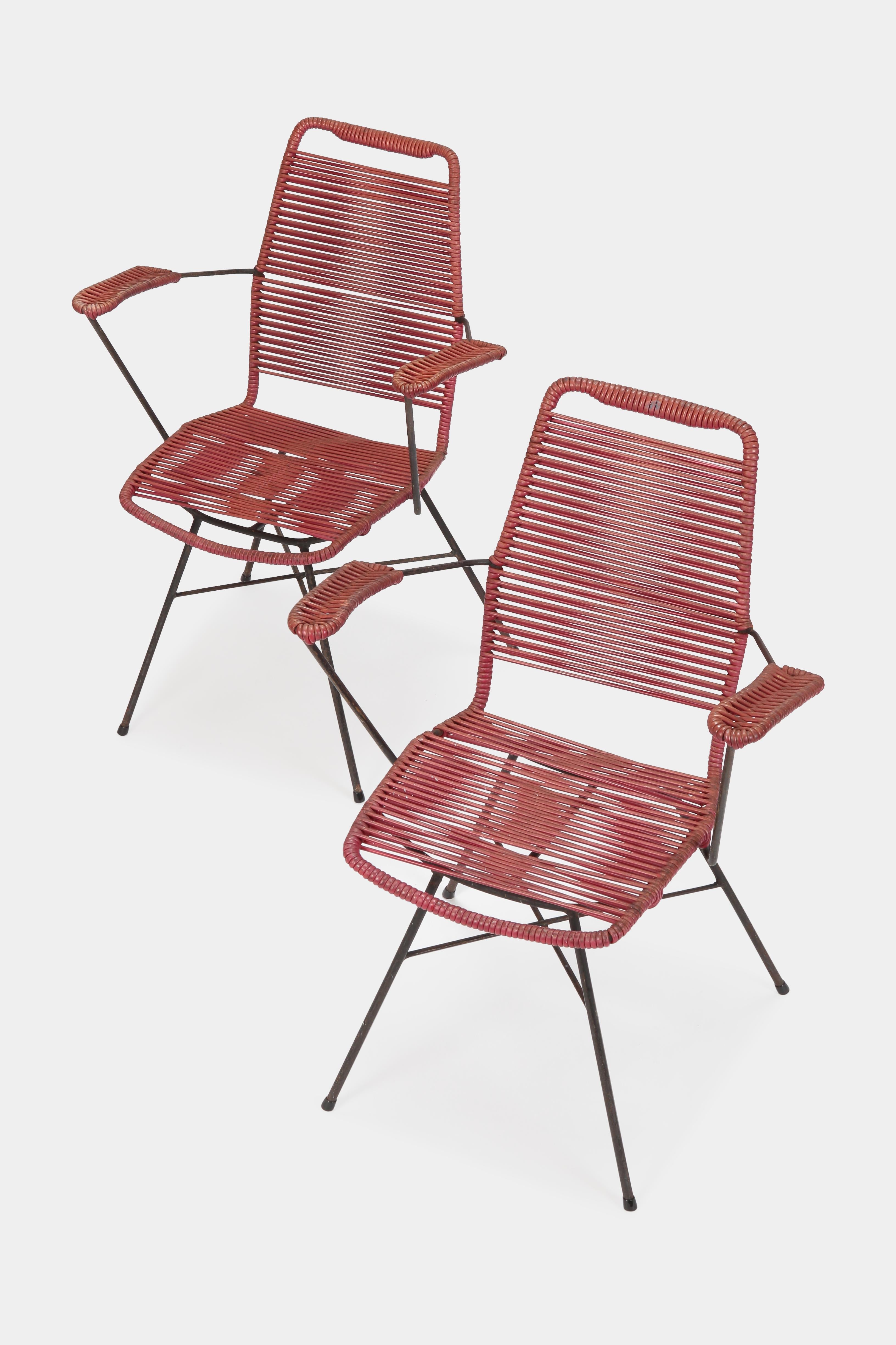 Attributed Gastone Rinaldi garden chairs manufactured in the 1950s in Italy. Red plastic strings attached to a black lacquered metal frame in beautiful vintage condition.
